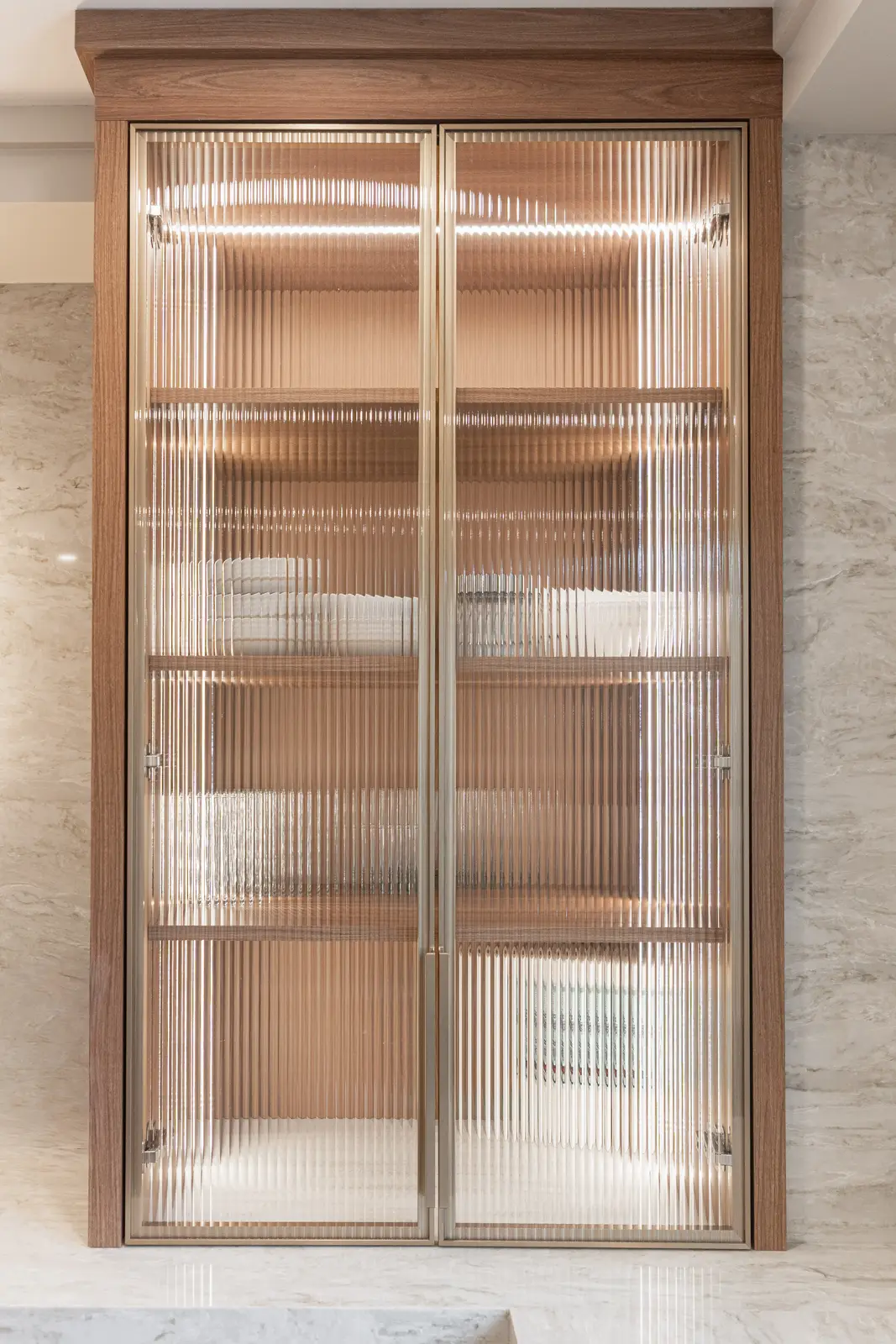 Interior of a Thornhill detached house renovation, with white cabinetry, light oak millwork, and a pale stone counter.