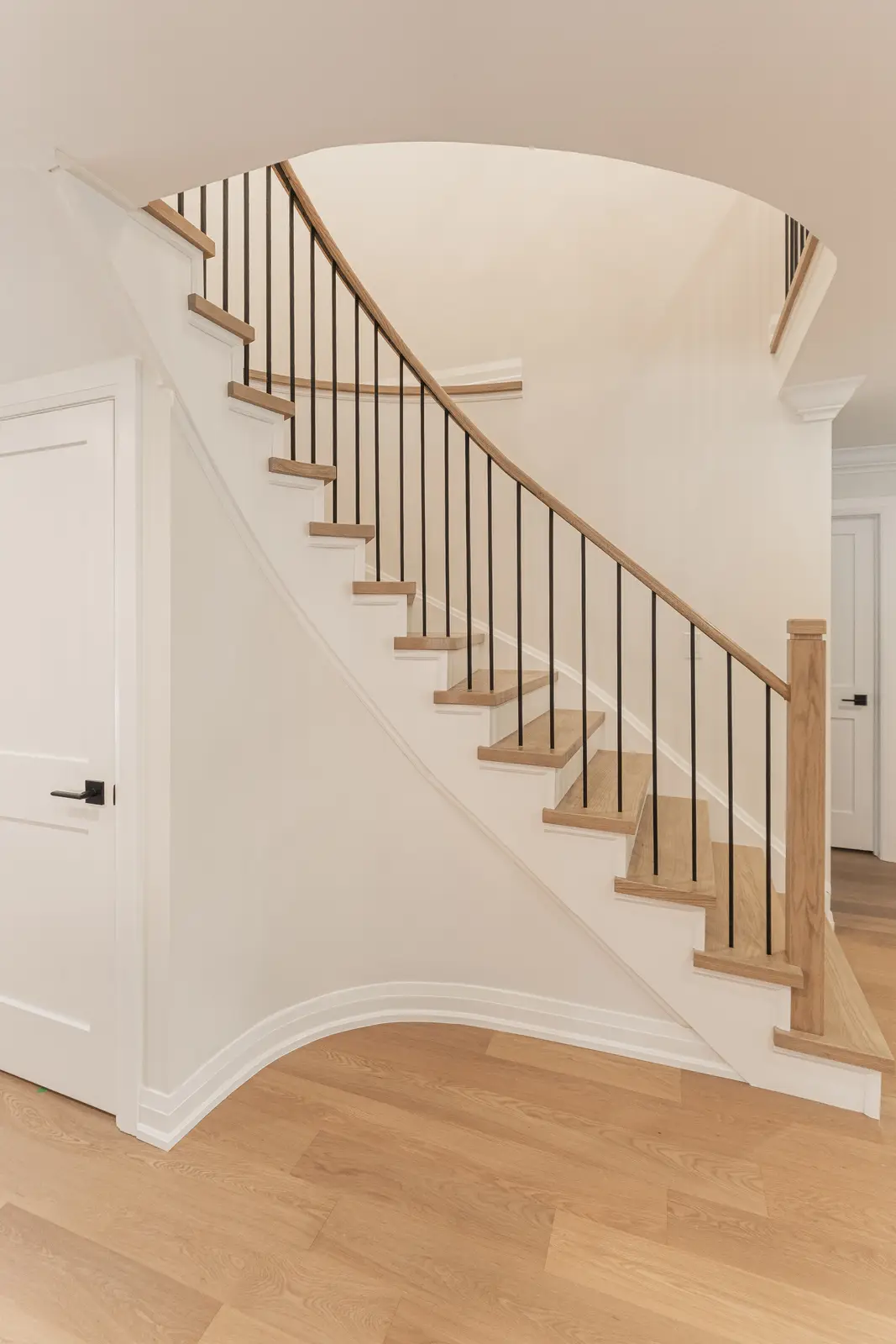 Interior of a Thornhill detached house renovation, with white cabinetry, light oak millwork, and a pale stone counter.