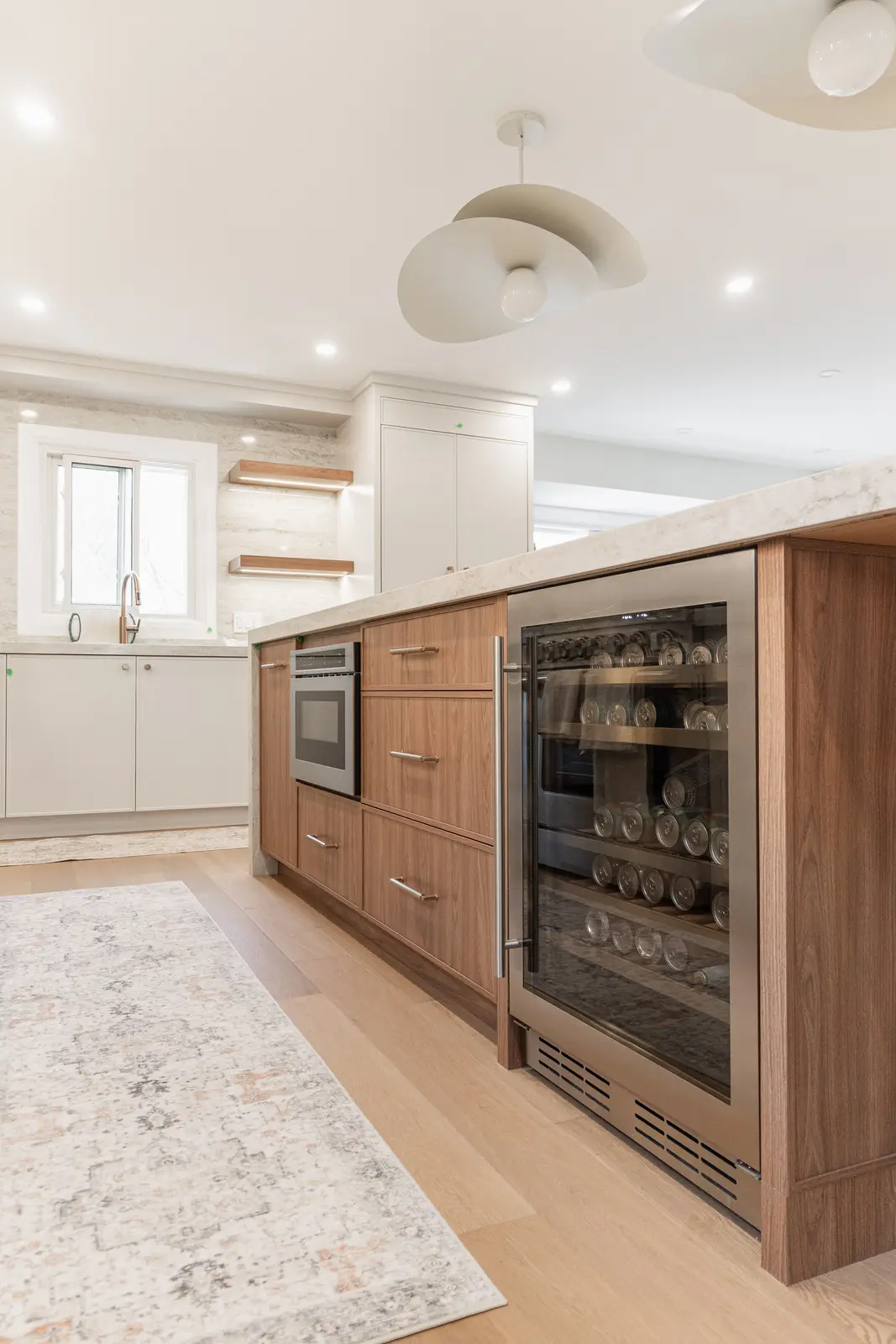 Interior of a Thornhill detached house renovation, with white cabinetry, light oak millwork, and a pale stone counter.