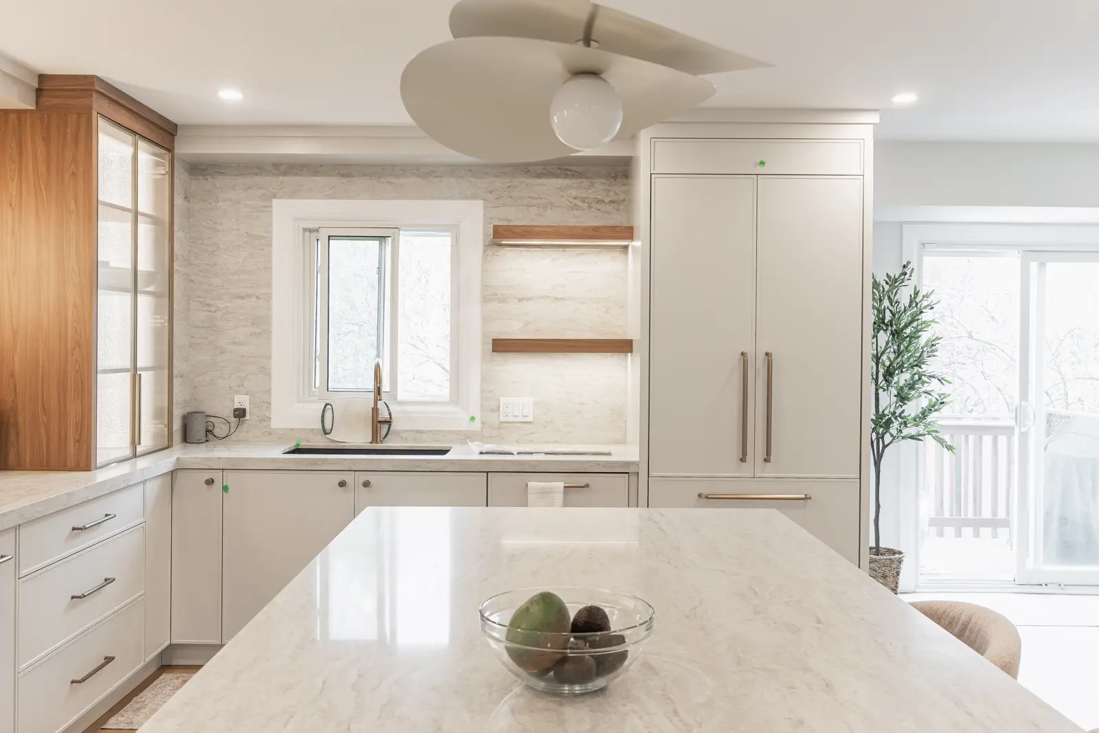 Interior of a Thornhill detached house renovation, with white cabinetry, light oak millwork, and a pale stone counter.