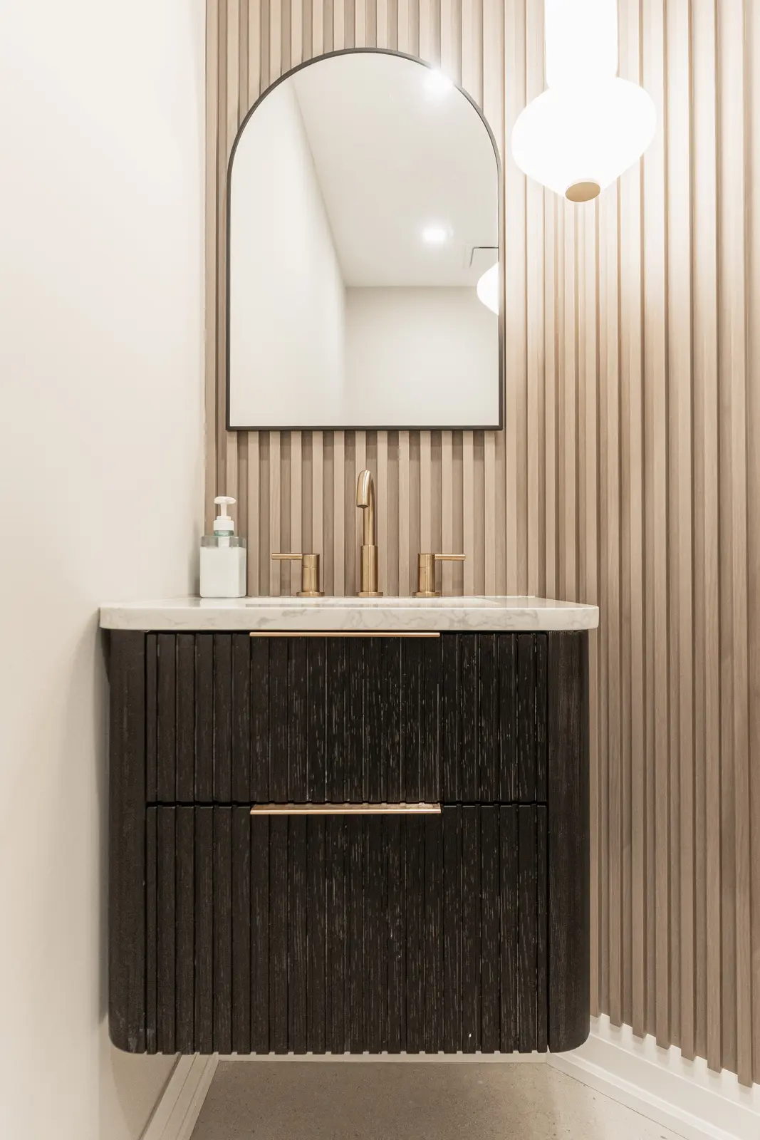 Interior of a Thornhill detached house renovation, with white cabinetry, light oak millwork, and a pale stone counter.
