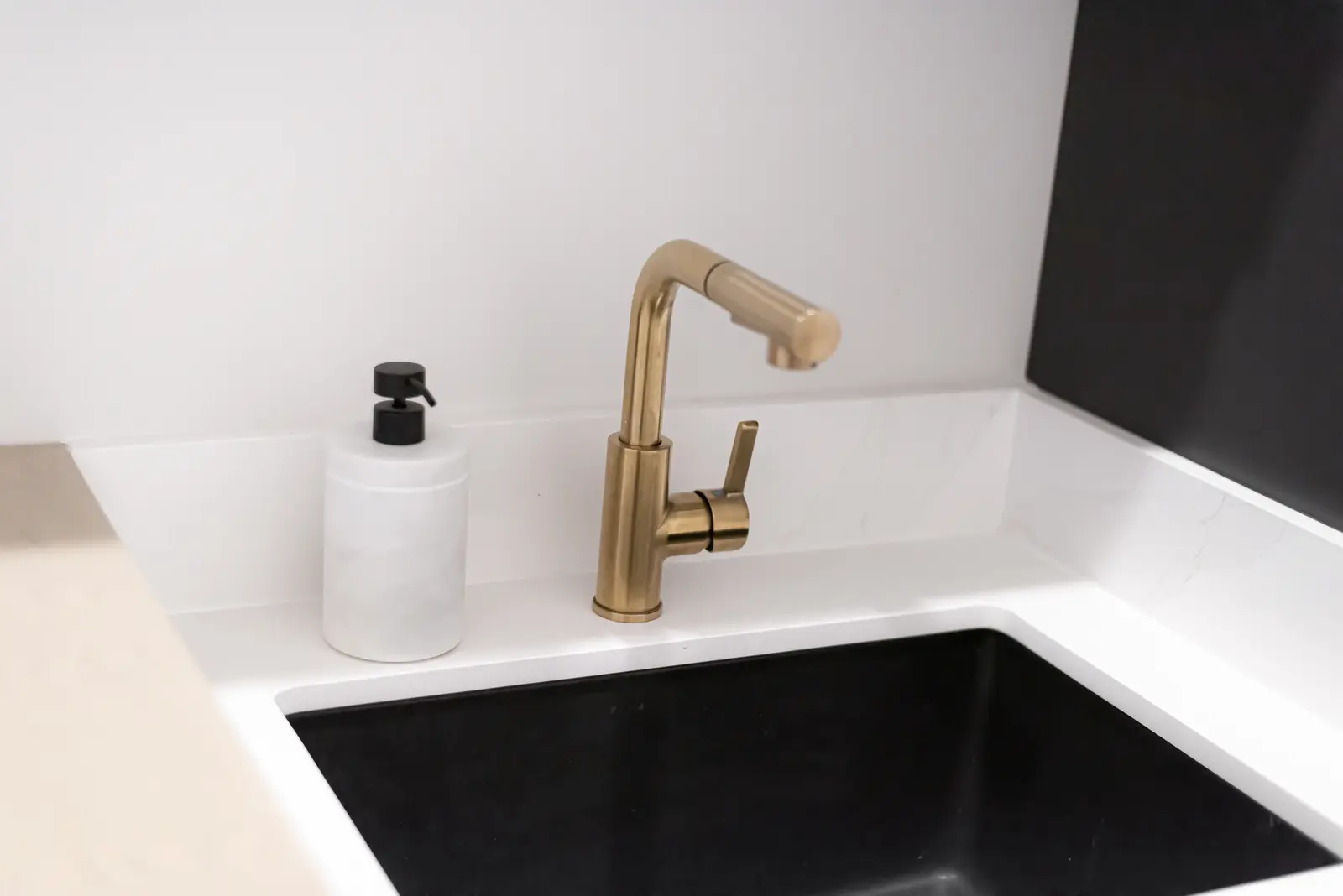 Interior of a Thornhill detached house renovation, with pale wood floors, black furnishings, and a walnut vanity in the primary bathroom.