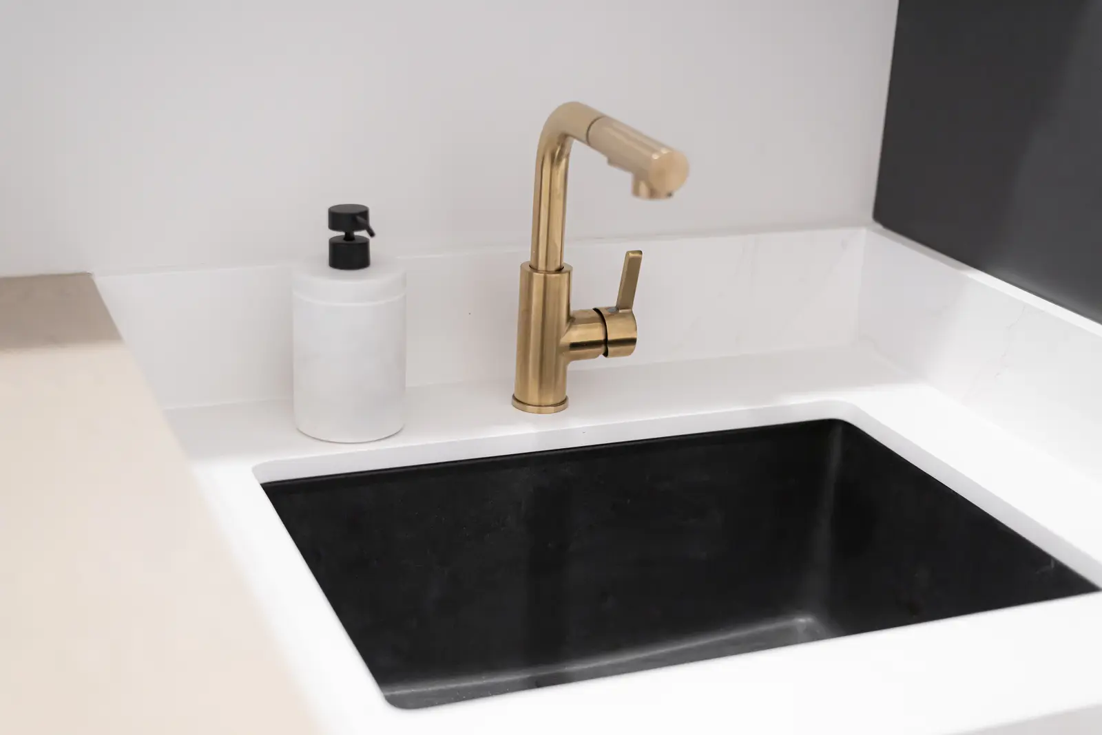 Interior of a Thornhill detached house renovation, with pale wood floors, black furnishings, and a walnut vanity in the primary bathroom.