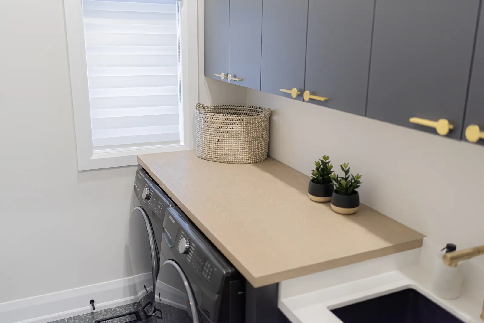 Interior of a Thornhill detached house renovation, with pale wood floors, black furnishings, and a walnut vanity in the primary bathroom.
