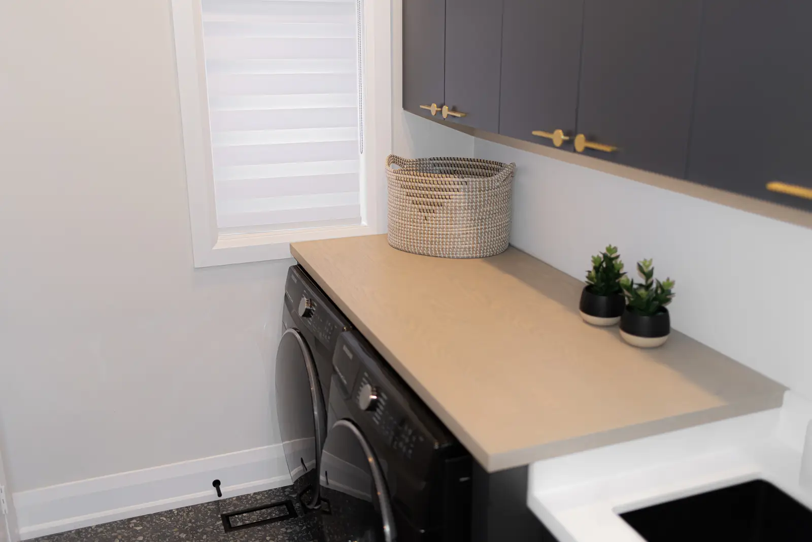 Interior of a Thornhill detached house renovation, with pale wood floors, black furnishings, and a walnut vanity in the primary bathroom.