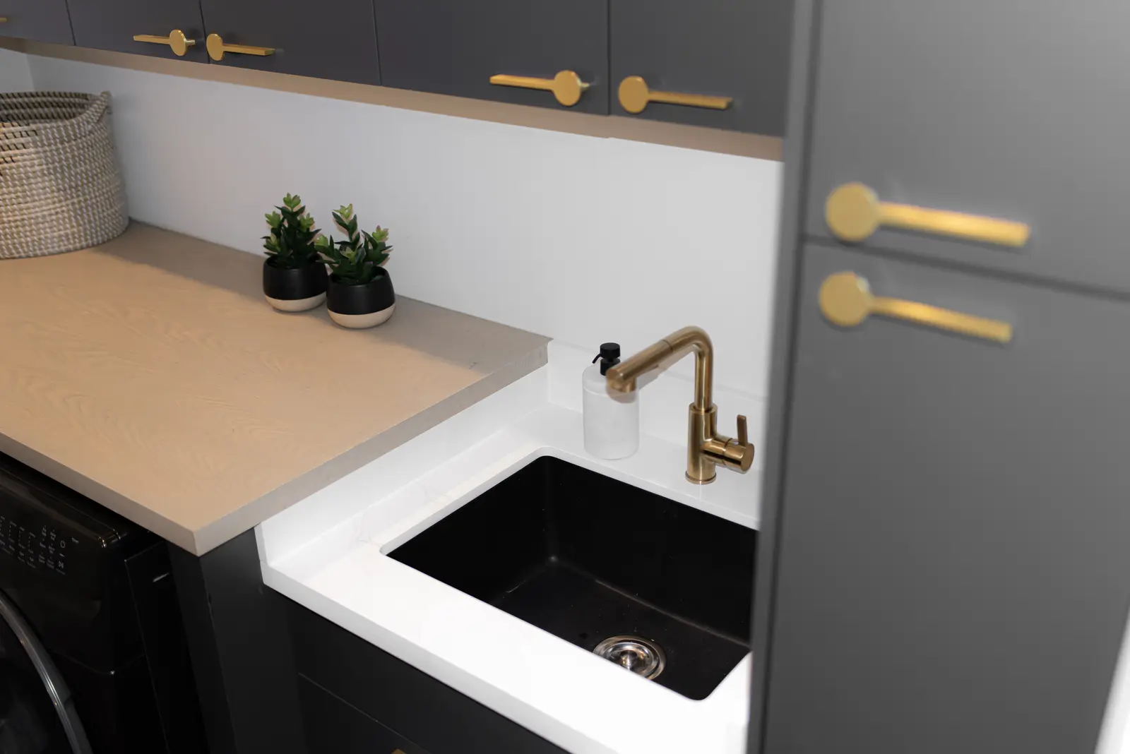 Interior of a Thornhill detached house renovation, with pale wood floors, black furnishings, and a walnut vanity in the primary bathroom.