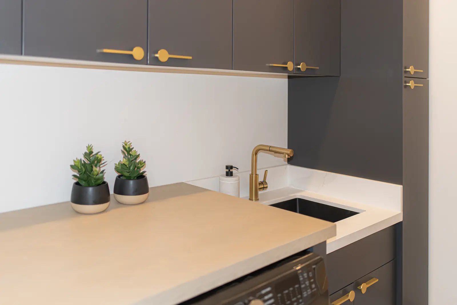 Interior of a Thornhill detached house renovation, with pale wood floors, black furnishings, and a walnut vanity in the primary bathroom.