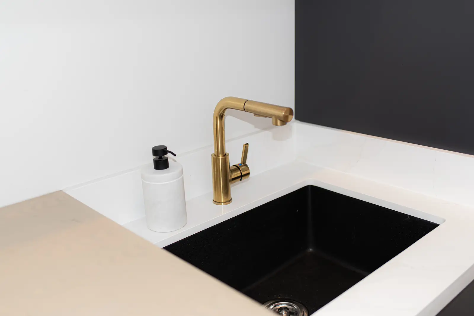 Interior of a Thornhill detached house renovation, with pale wood floors, black furnishings, and a walnut vanity in the primary bathroom.