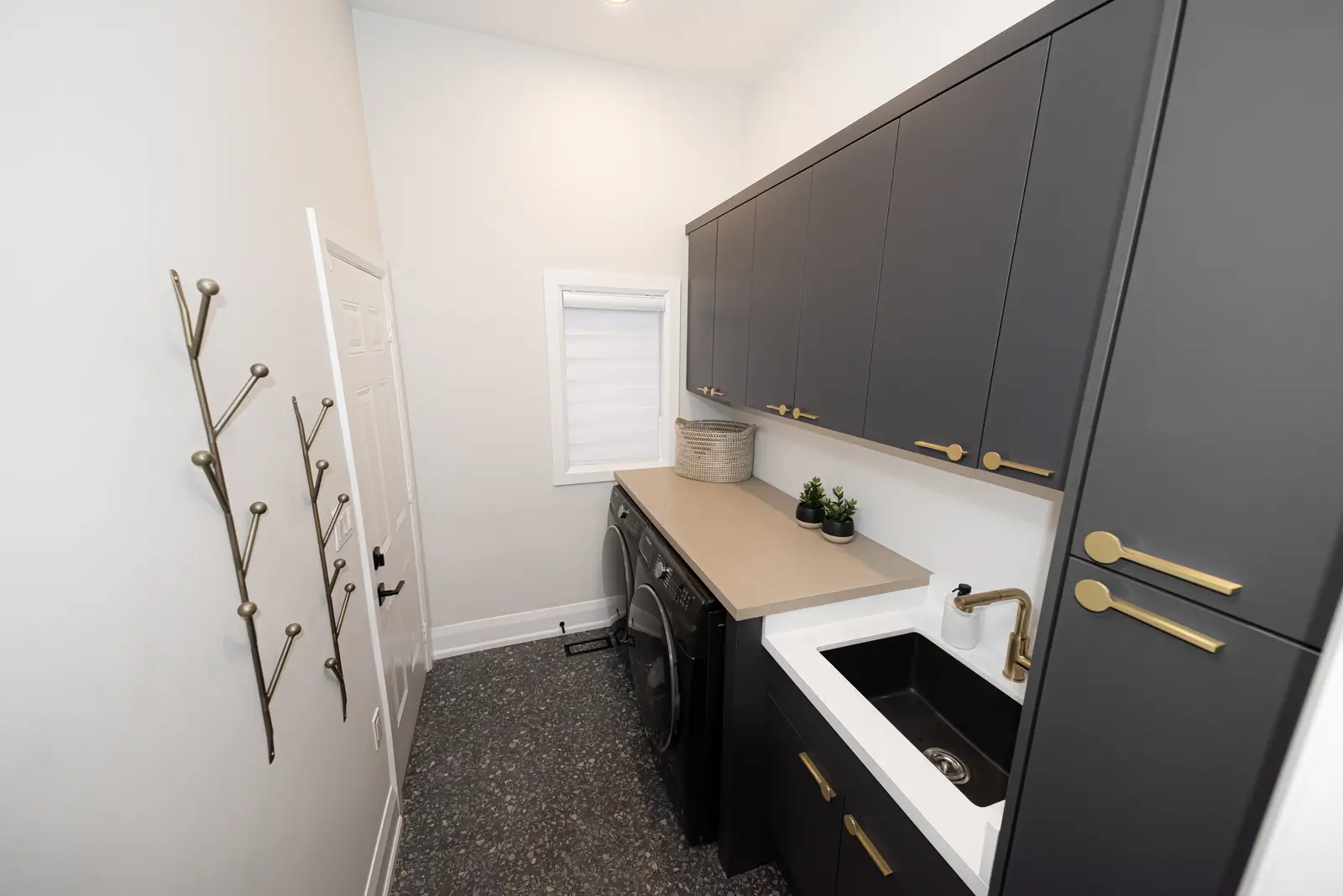 Interior of a Thornhill detached house renovation, with pale wood floors, black furnishings, and a walnut vanity in the primary bathroom.