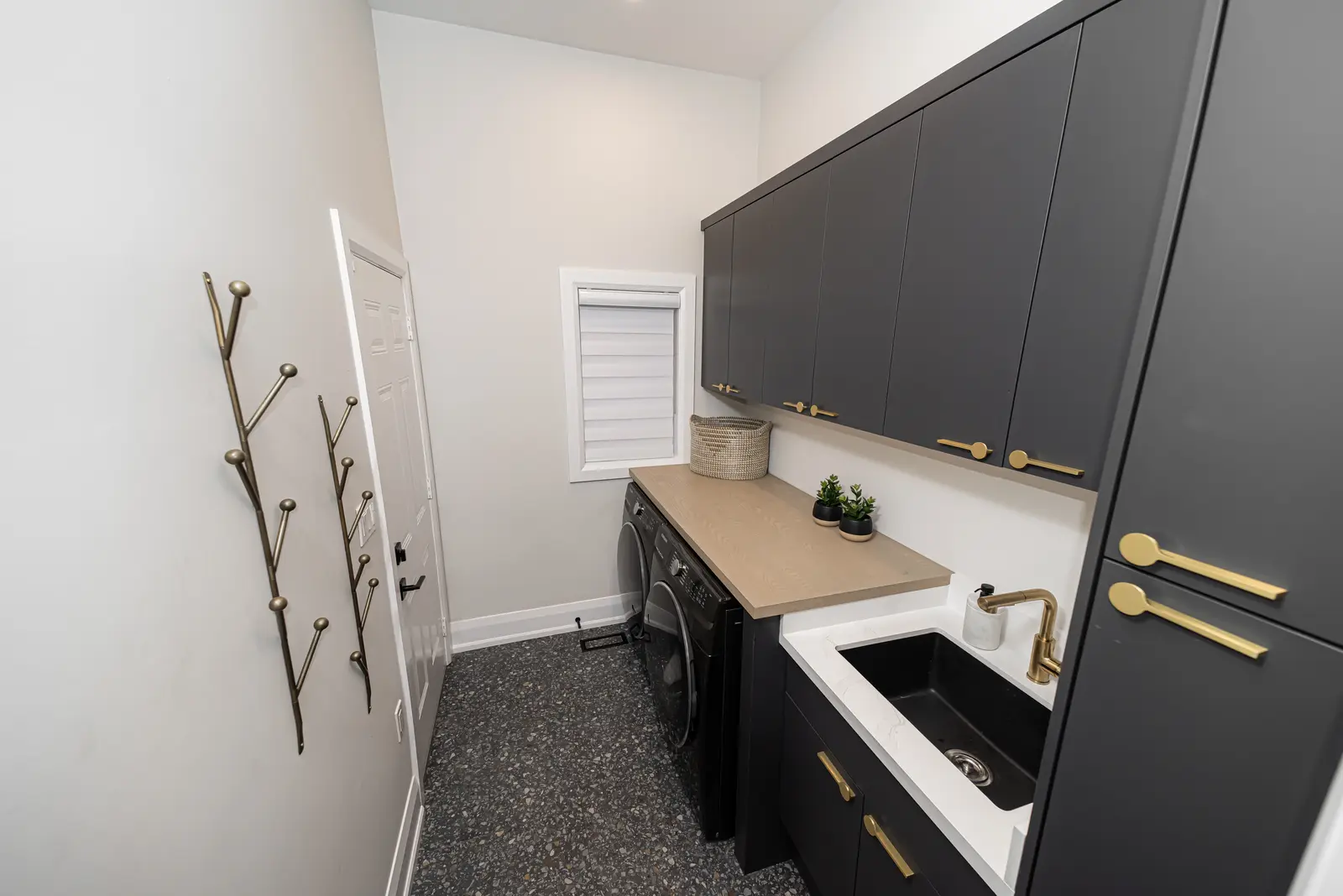 Interior of a Thornhill detached house renovation, with pale wood floors, black furnishings, and a walnut vanity in the primary bathroom.