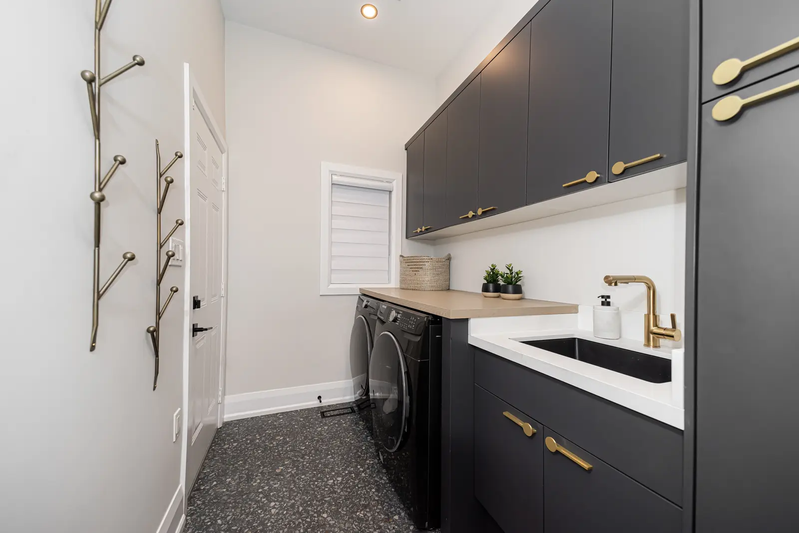 Interior of a Thornhill detached house renovation, with pale wood floors, black furnishings, and a walnut vanity in the primary bathroom.