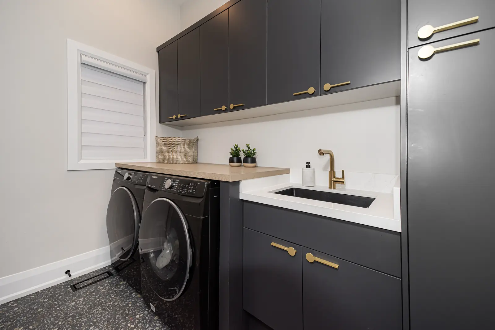 Interior of a Thornhill detached house renovation, with pale wood floors, black furnishings, and a walnut vanity in the primary bathroom.