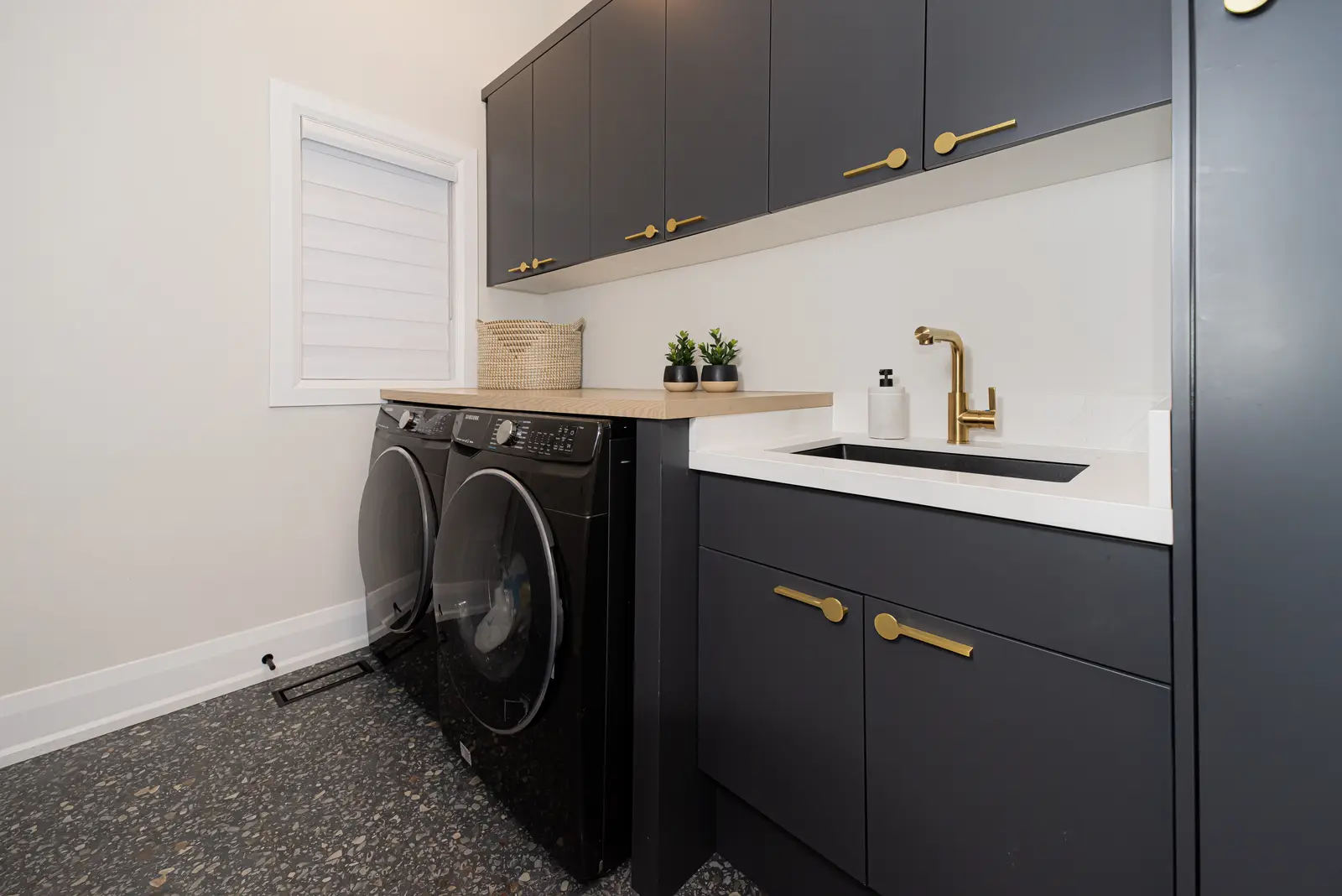 Interior of a Thornhill detached house renovation, with pale wood floors, black furnishings, and a walnut vanity in the primary bathroom.