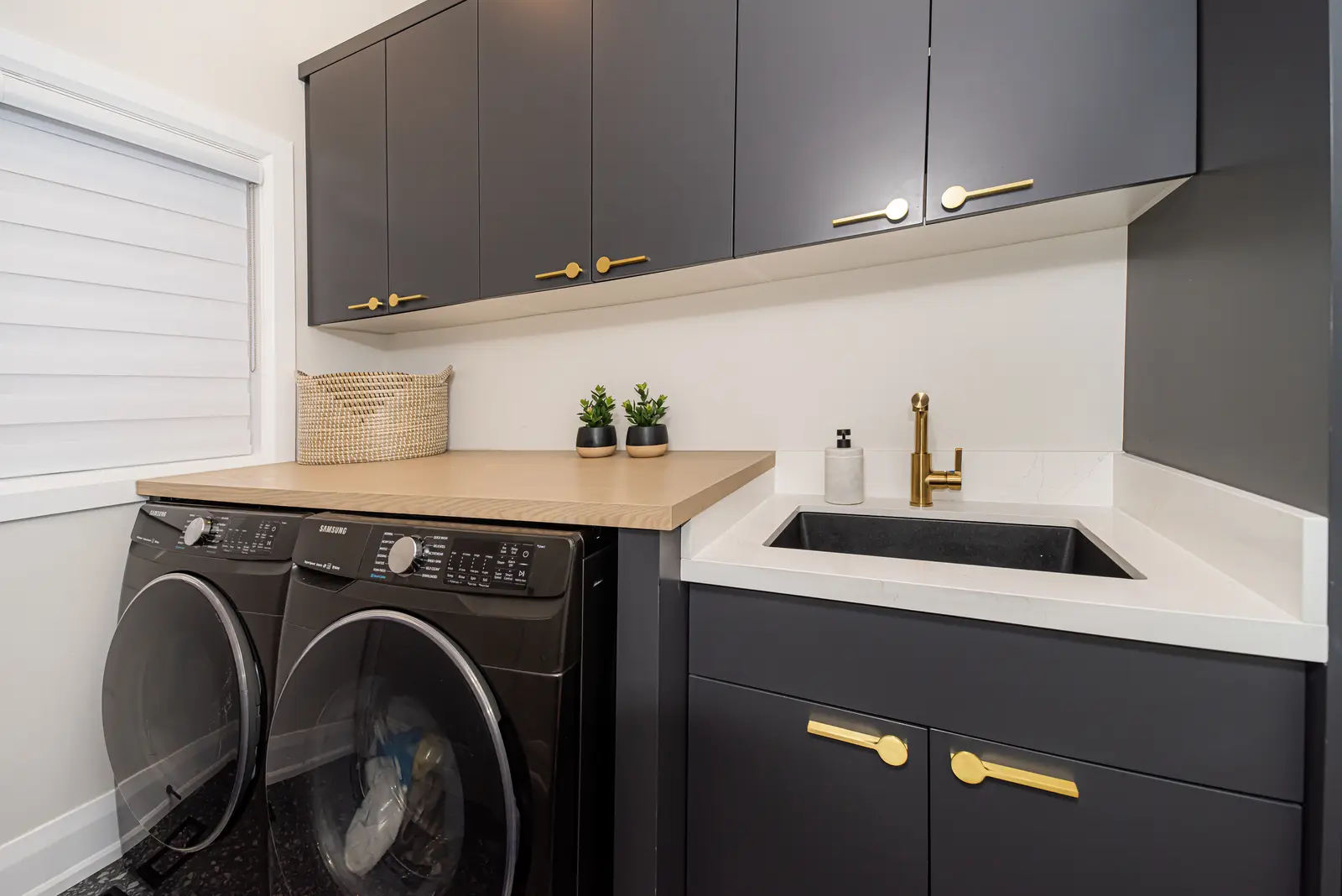 Interior of a Thornhill detached house renovation, with pale wood floors, black furnishings, and a walnut vanity in the primary bathroom.
