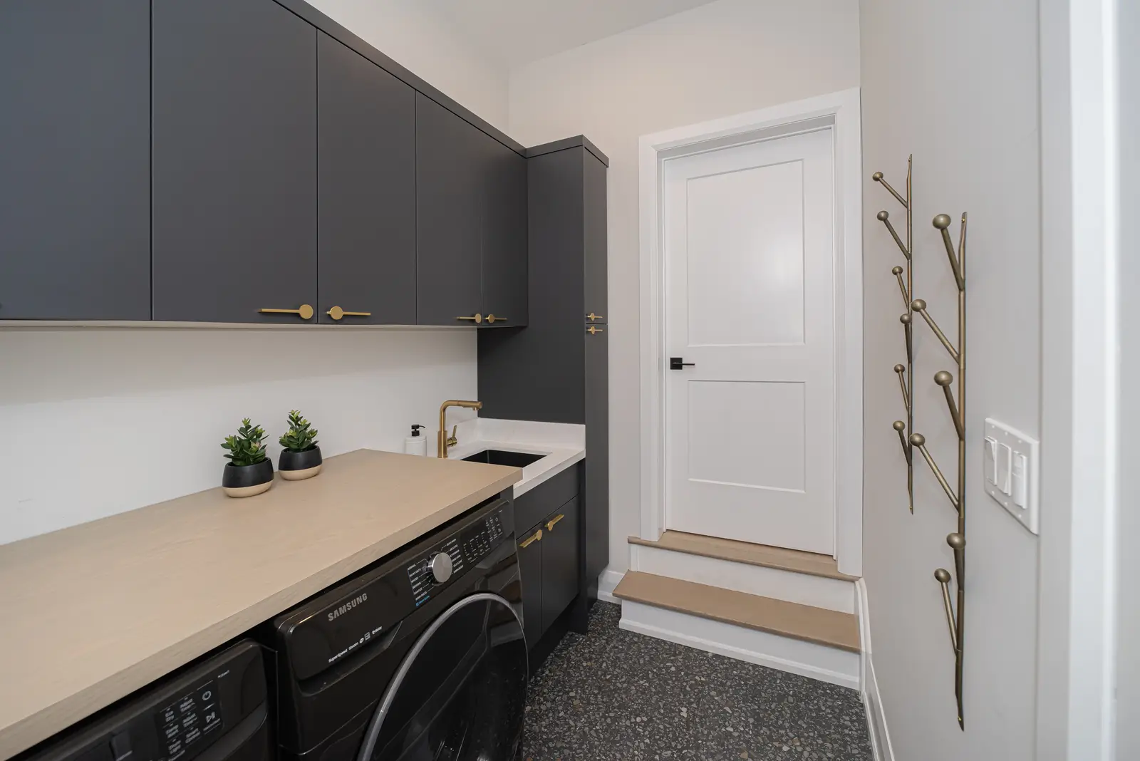 Interior of a Thornhill detached house renovation, with pale wood floors, black furnishings, and a walnut vanity in the primary bathroom.