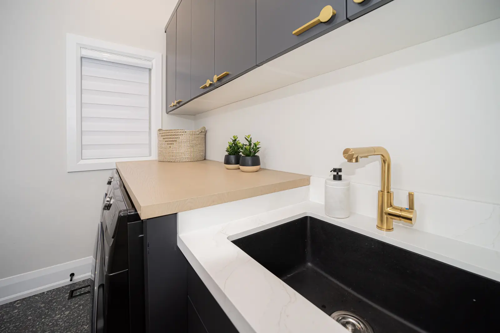 Interior of a Thornhill detached house renovation, with pale wood floors, black furnishings, and a walnut vanity in the primary bathroom.