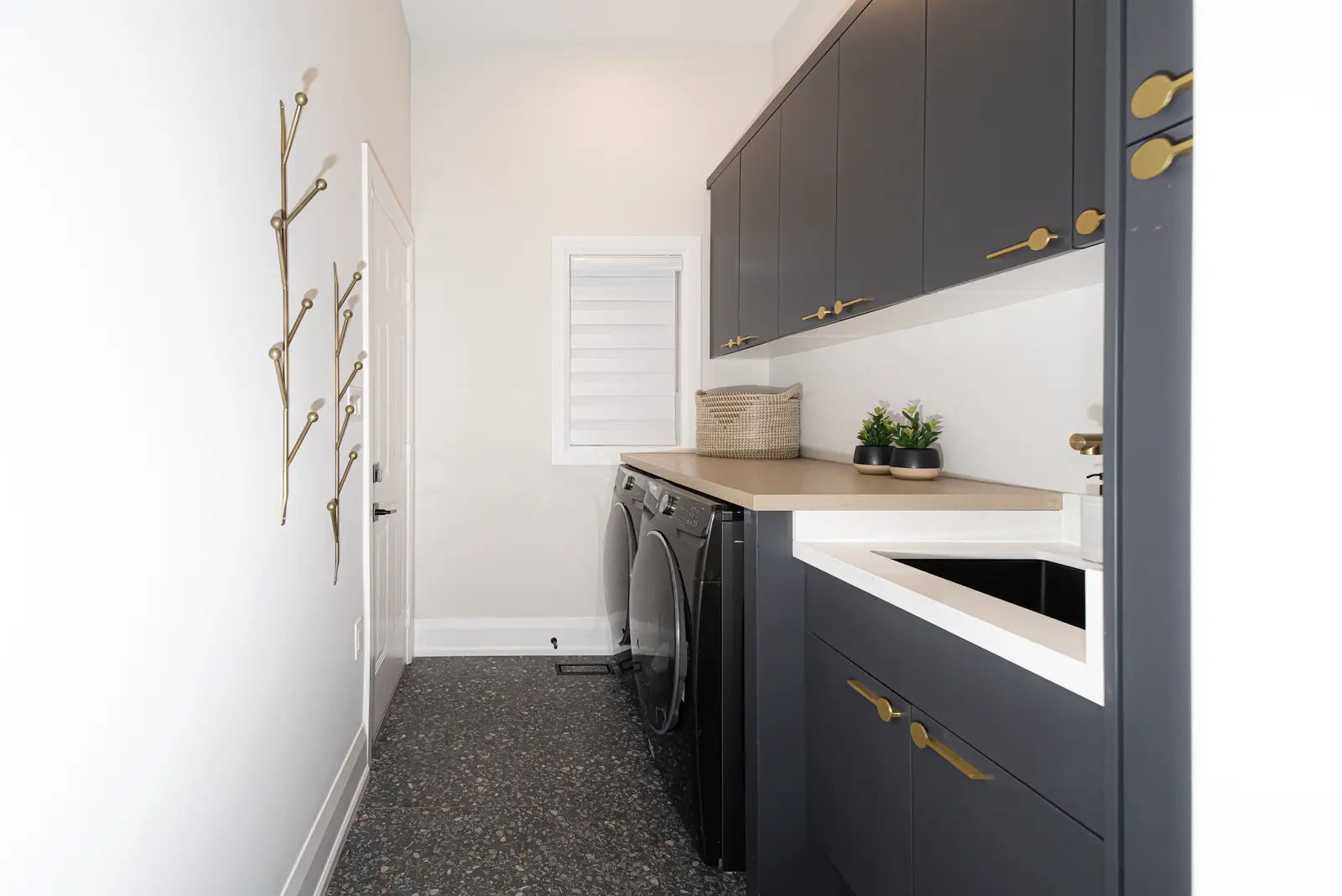 Interior of a Thornhill detached house renovation, with pale wood floors, black furnishings, and a walnut vanity in the primary bathroom.