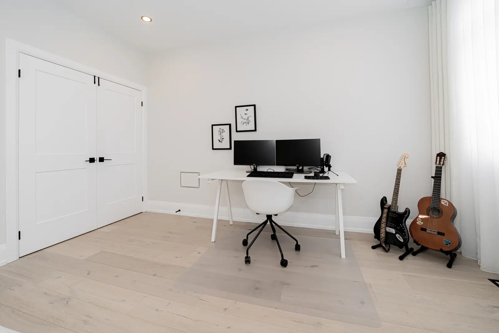 Interior of a Thornhill detached house renovation, with pale wood floors, black furnishings, and a walnut vanity in the primary bathroom.