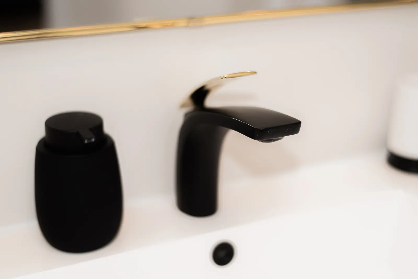 Interior of a Thornhill detached house renovation, with pale wood floors, black furnishings, and a walnut vanity in the primary bathroom.