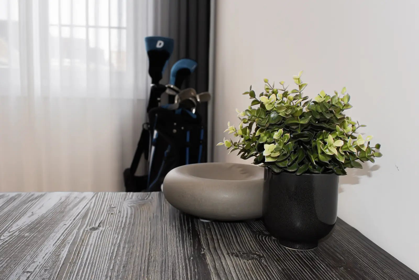 Interior of a Thornhill detached house renovation, with pale wood floors, black furnishings, and a walnut vanity in the primary bathroom.