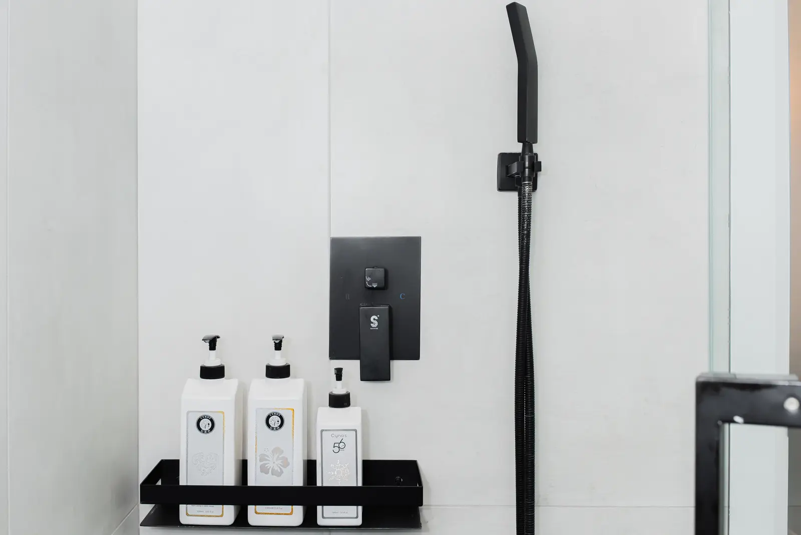 Interior of a Thornhill detached house renovation, with pale wood floors, black furnishings, and a walnut vanity in the primary bathroom.