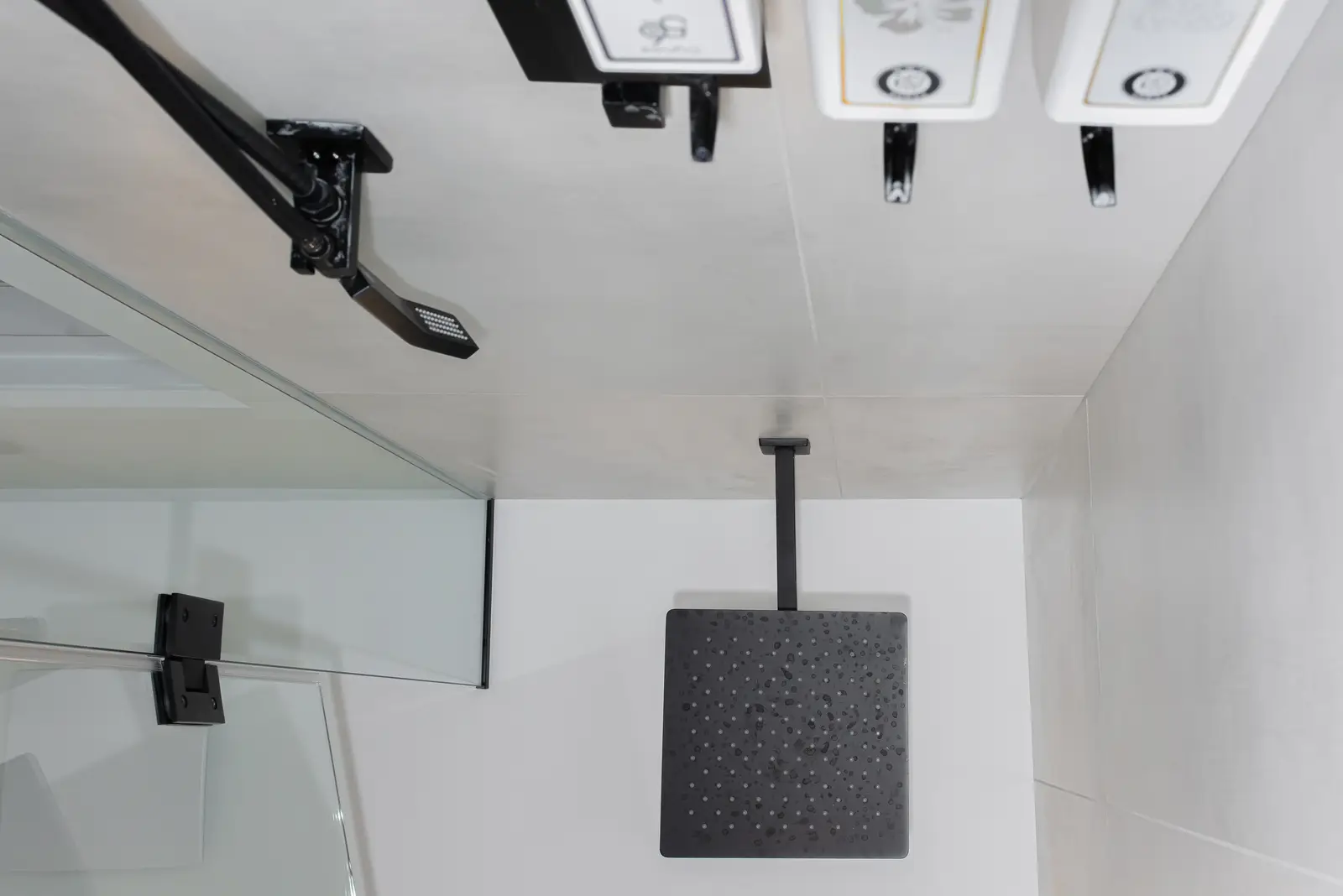 Interior of a Thornhill detached house renovation, with pale wood floors, black furnishings, and a walnut vanity in the primary bathroom.