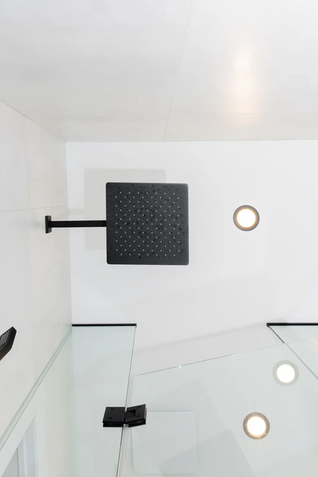 Interior of a Thornhill detached house renovation, with pale wood floors, black furnishings, and a walnut vanity in the primary bathroom.