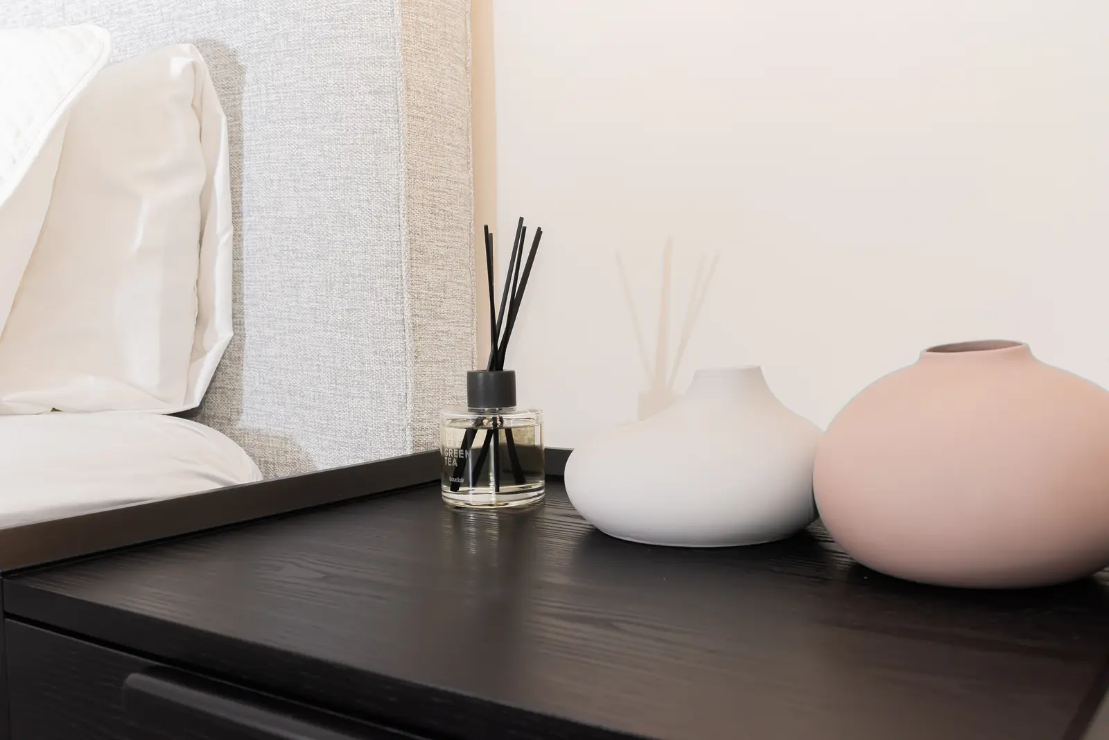 Interior of a Thornhill detached house renovation, with pale wood floors, black furnishings, and a walnut vanity in the primary bathroom.