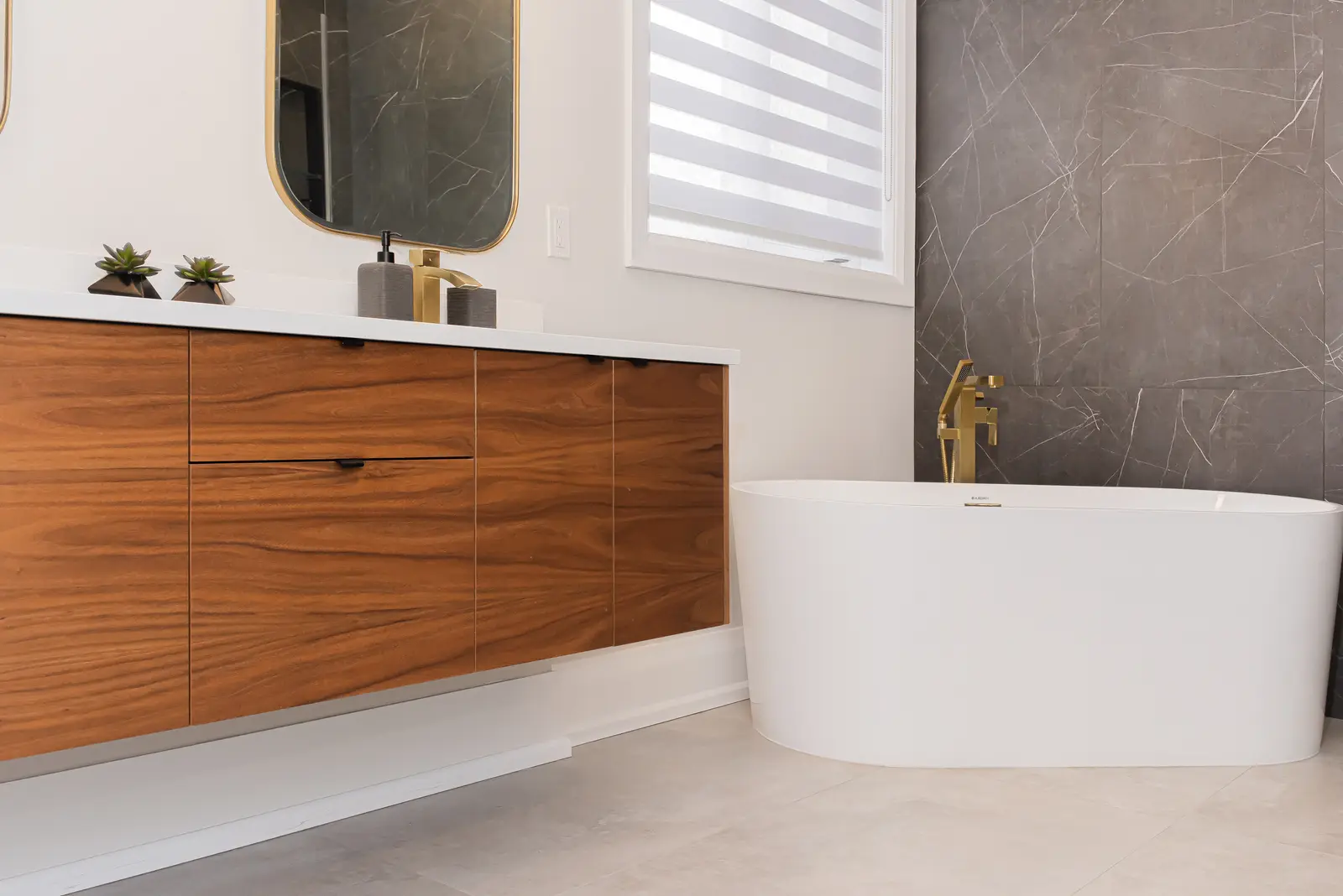 Interior of a Thornhill detached house renovation, with pale wood floors, black furnishings, and a walnut vanity in the primary bathroom.
