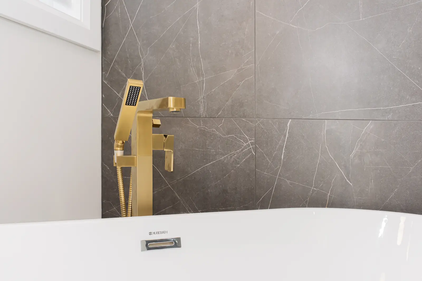 Interior of a Thornhill detached house renovation, with pale wood floors, black furnishings, and a walnut vanity in the primary bathroom.