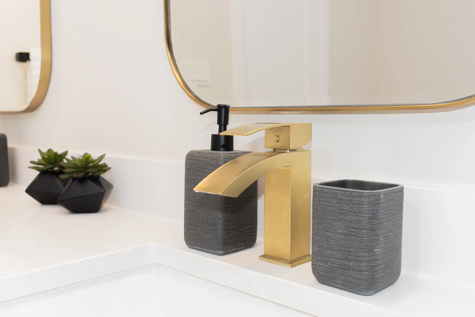 Interior of a Thornhill detached house renovation, with pale wood floors, black furnishings, and a walnut vanity in the primary bathroom.