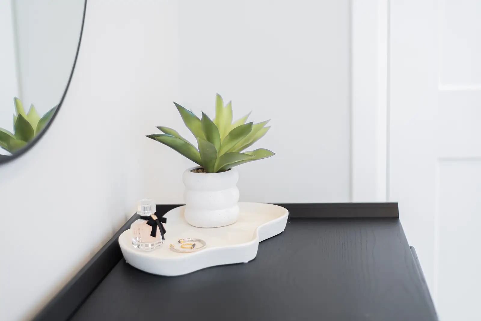 Interior of a Thornhill detached house renovation, with pale wood floors, black furnishings, and a walnut vanity in the primary bathroom.