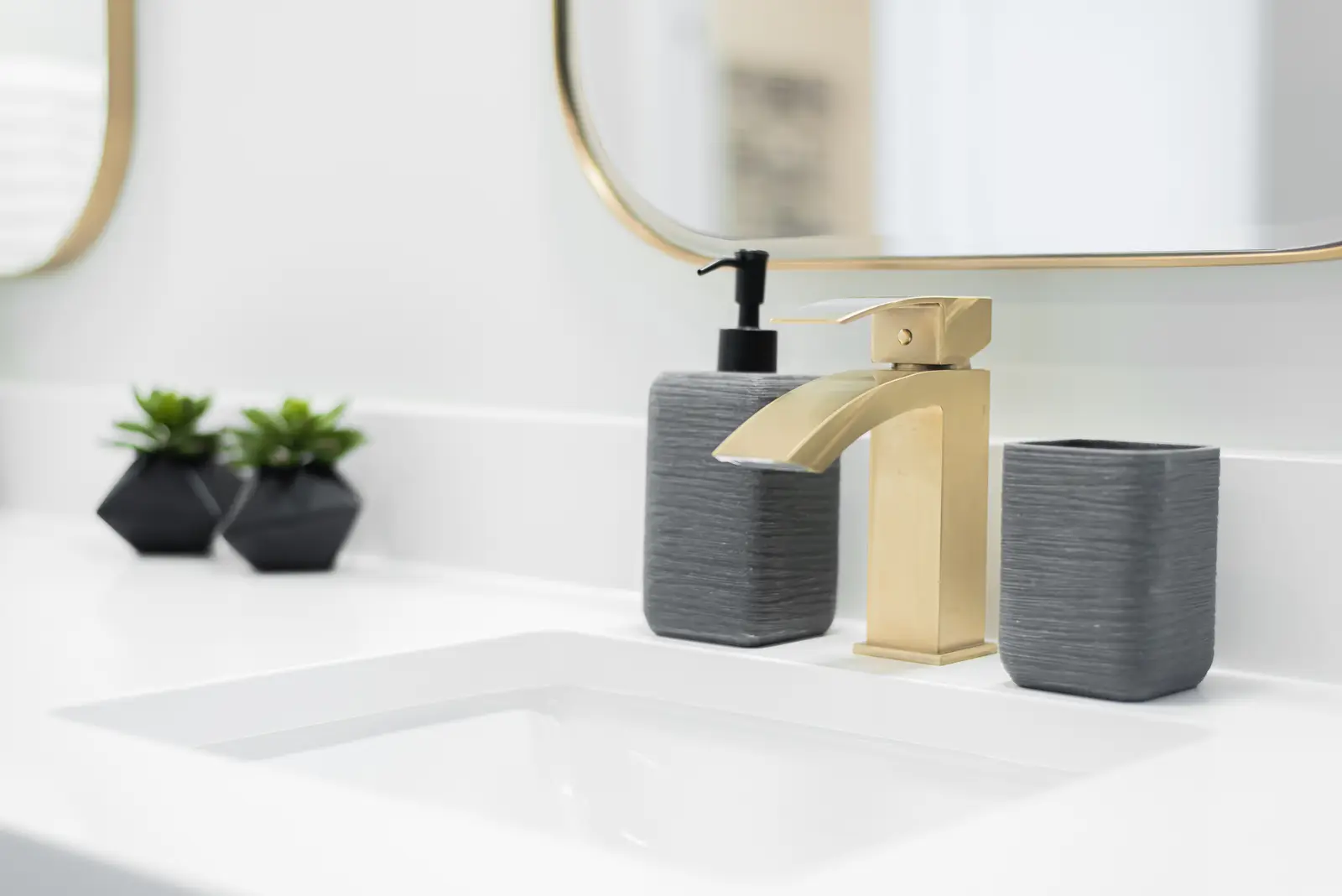 Interior of a Thornhill detached house renovation, with pale wood floors, black furnishings, and a walnut vanity in the primary bathroom.