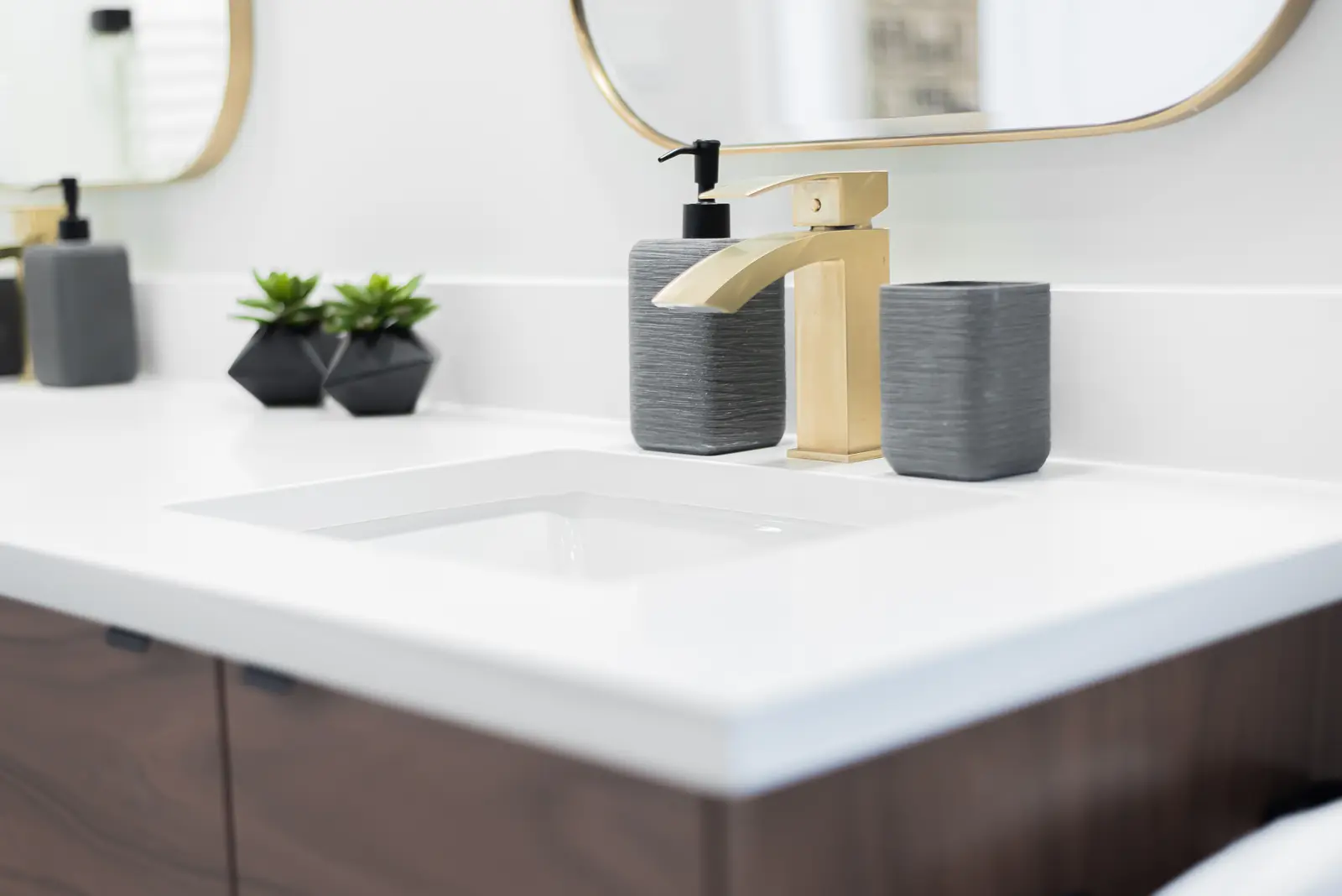 Interior of a Thornhill detached house renovation, with pale wood floors, black furnishings, and a walnut vanity in the primary bathroom.