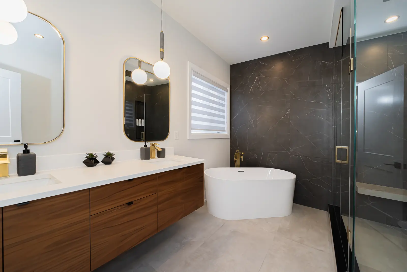 Interior of a Thornhill detached house renovation, with pale wood floors, black furnishings, and a walnut vanity in the primary bathroom.