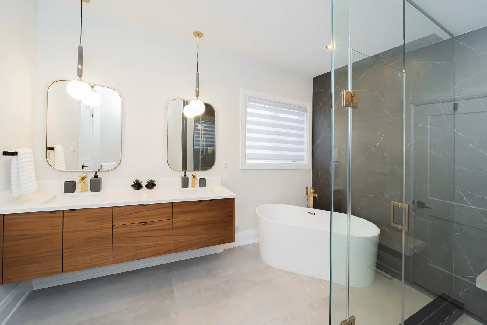 Interior of a Thornhill detached house renovation, with pale wood floors, black furnishings, and a walnut vanity in the primary bathroom.
