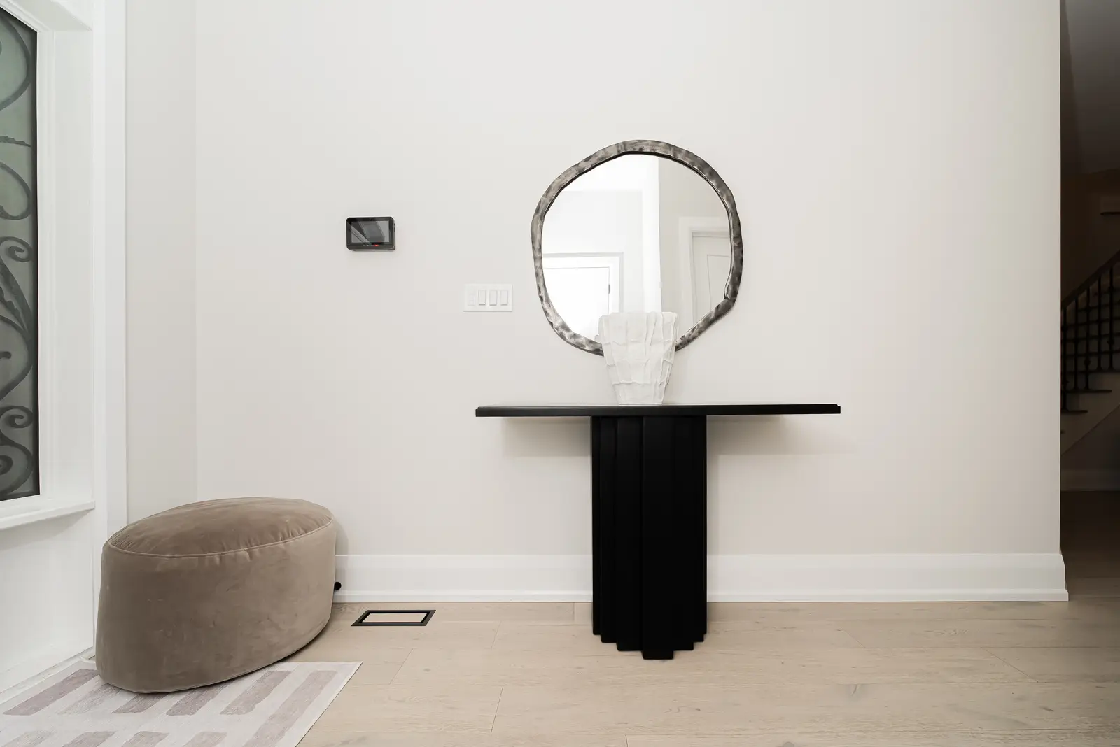 Interior of a Thornhill detached house renovation, with pale wood floors, black furnishings, and a walnut vanity in the primary bathroom.
