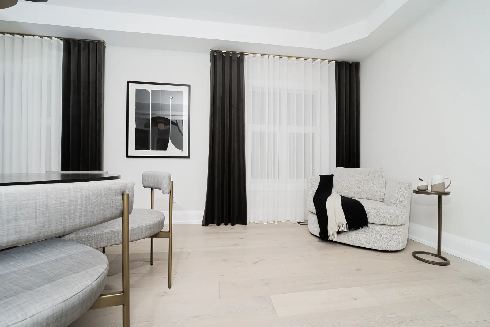 Interior of a Thornhill detached house renovation, with pale wood floors, black furnishings, and a walnut vanity in the primary bathroom.