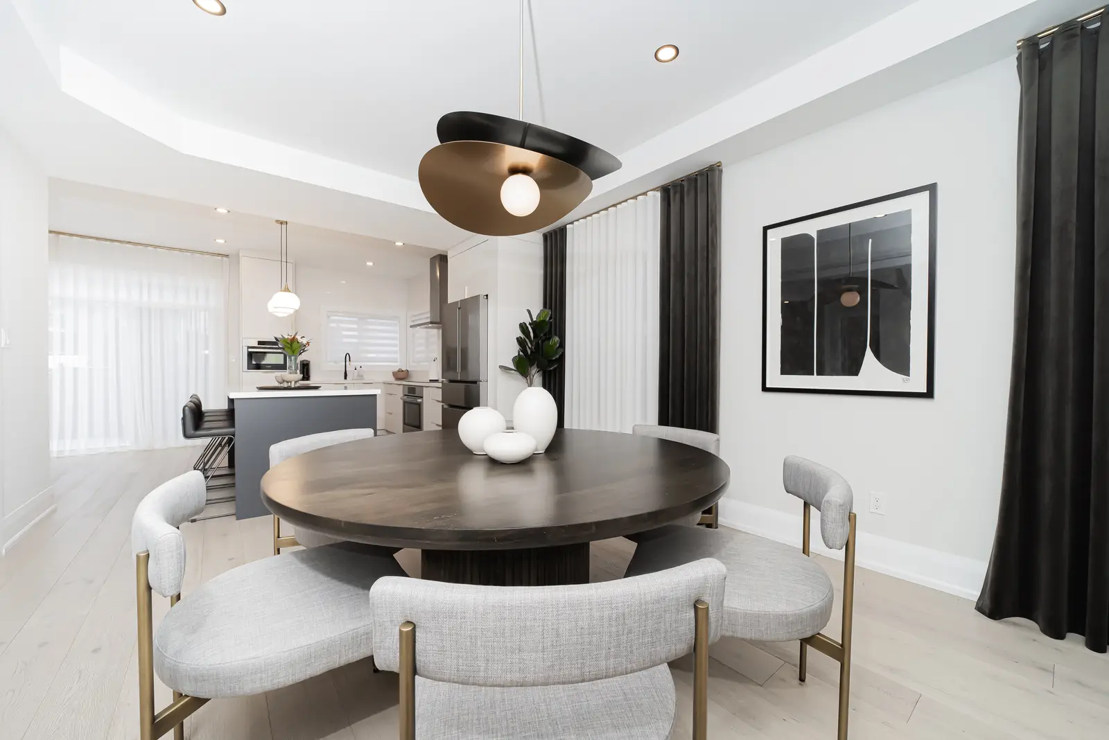 Interior of a Thornhill detached house renovation, with pale wood floors, black furnishings, and a walnut vanity in the primary bathroom.