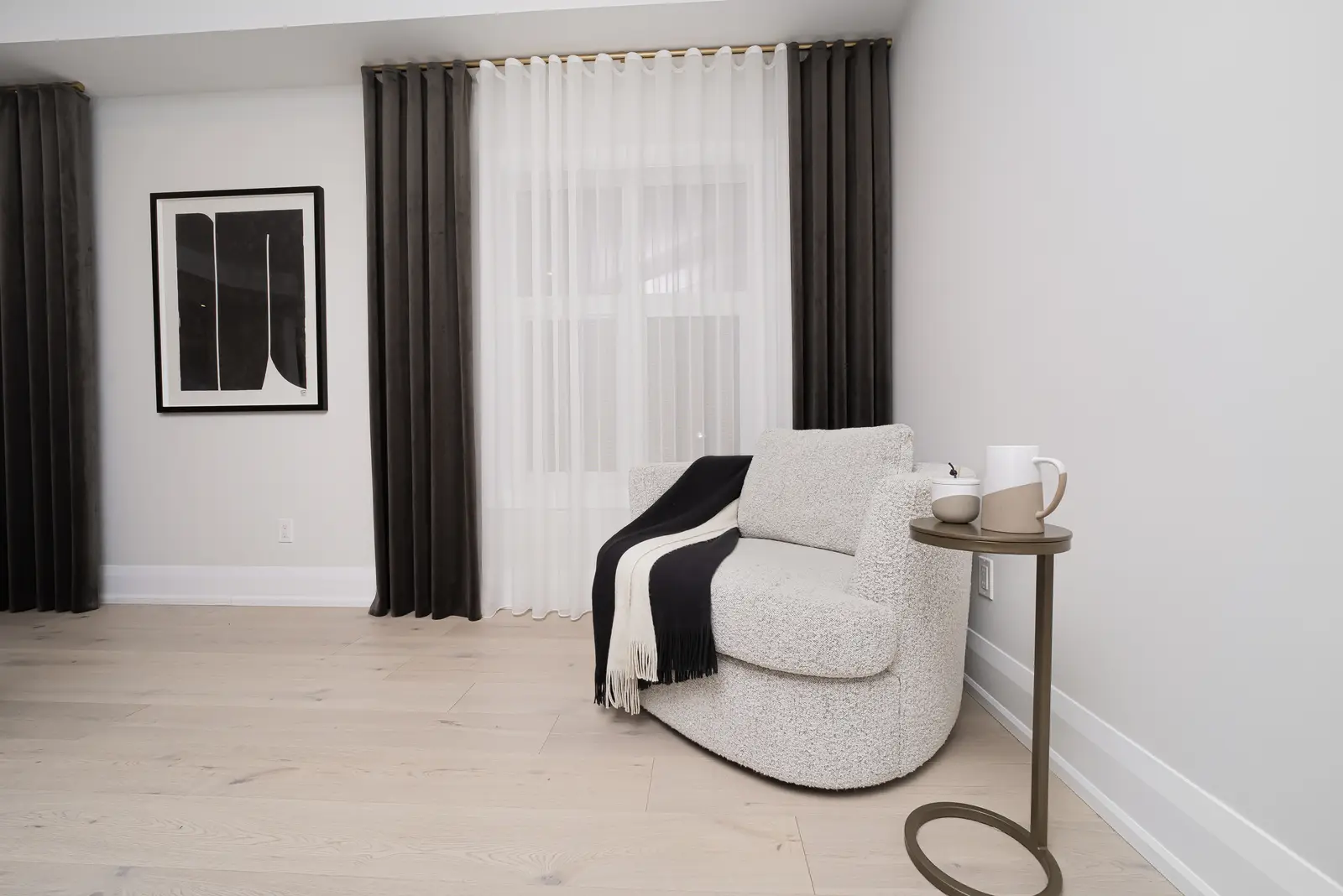 Interior of a Thornhill detached house renovation, with pale wood floors, black furnishings, and a walnut vanity in the primary bathroom.