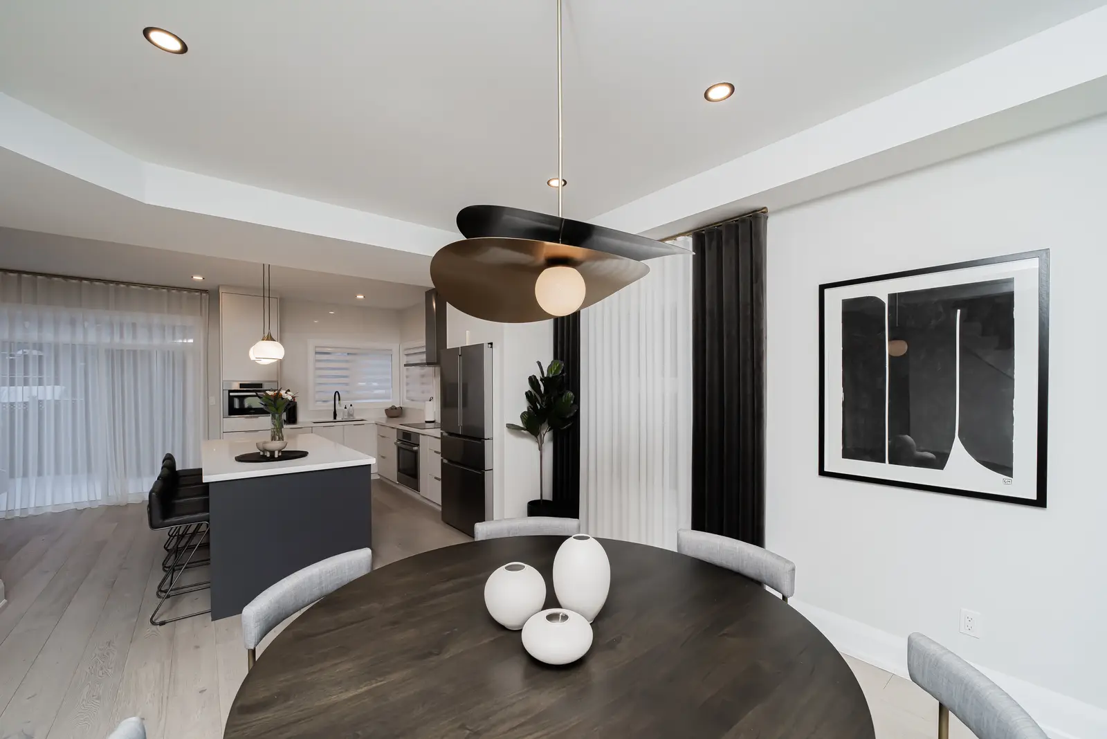 Interior of a Thornhill detached house renovation, with pale wood floors, black furnishings, and a walnut vanity in the primary bathroom.