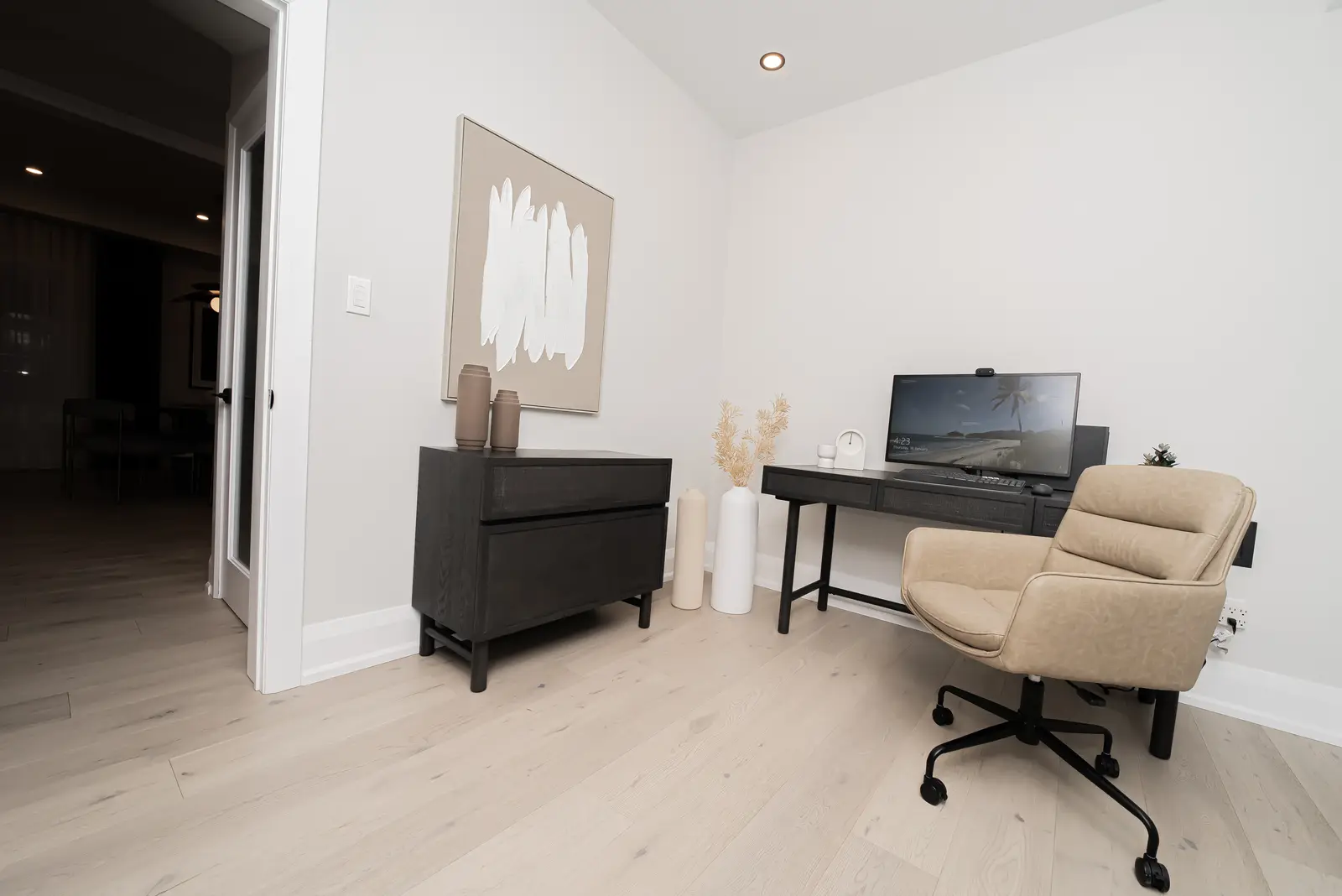 Interior of a Thornhill detached house renovation, with pale wood floors, black furnishings, and a walnut vanity in the primary bathroom.