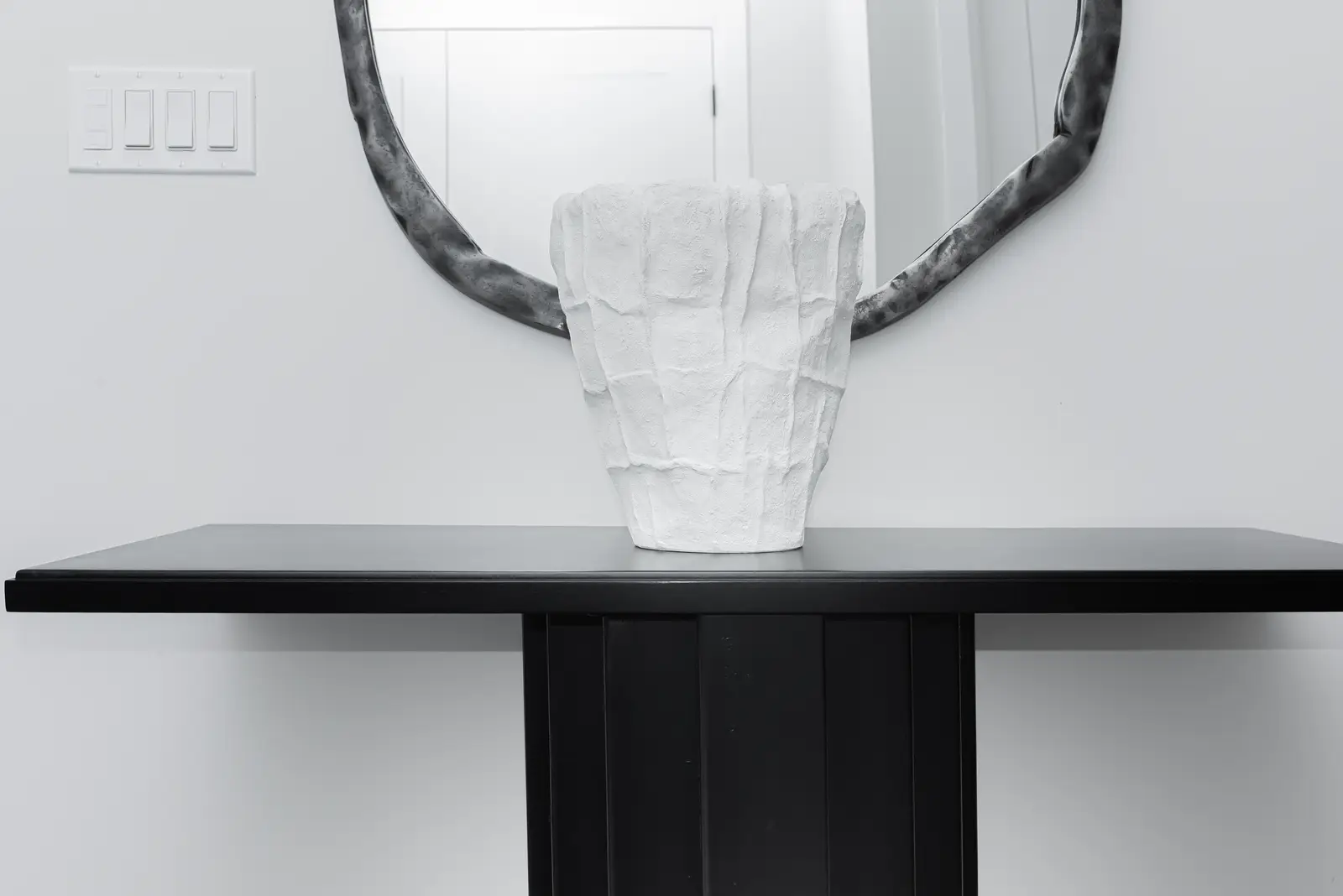 Interior of a Thornhill detached house renovation, with pale wood floors, black furnishings, and a walnut vanity in the primary bathroom.