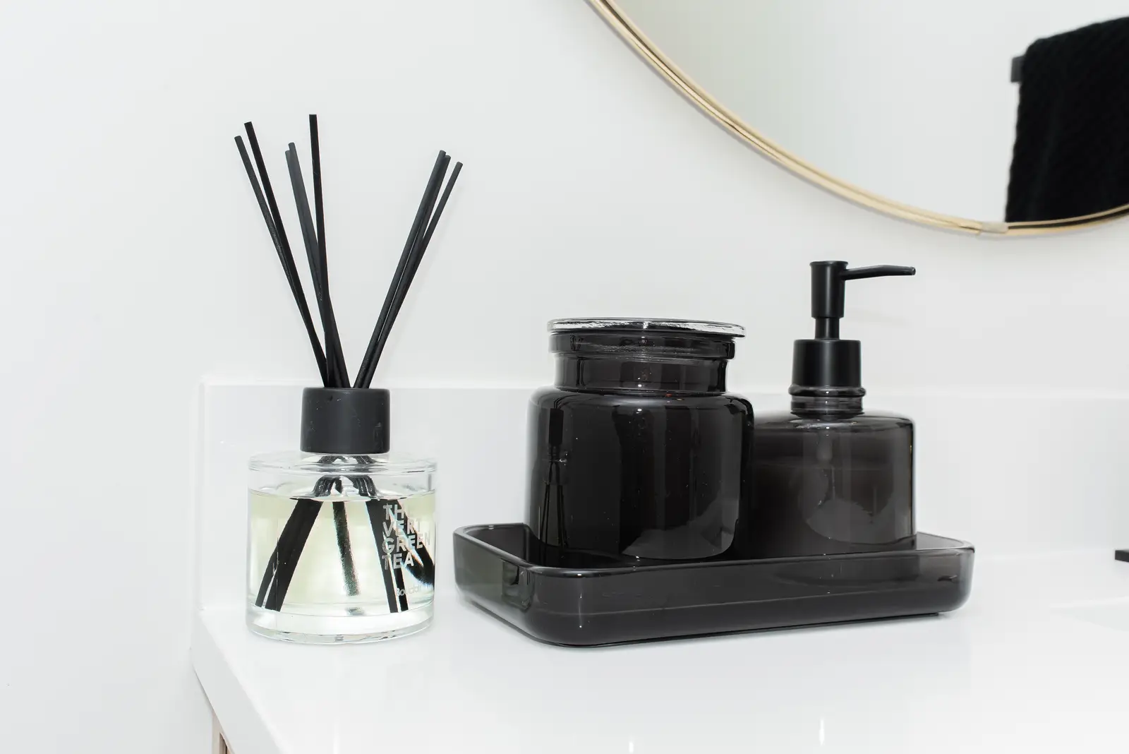 Interior of a Thornhill detached house renovation, with pale wood floors, black furnishings, and a walnut vanity in the primary bathroom.