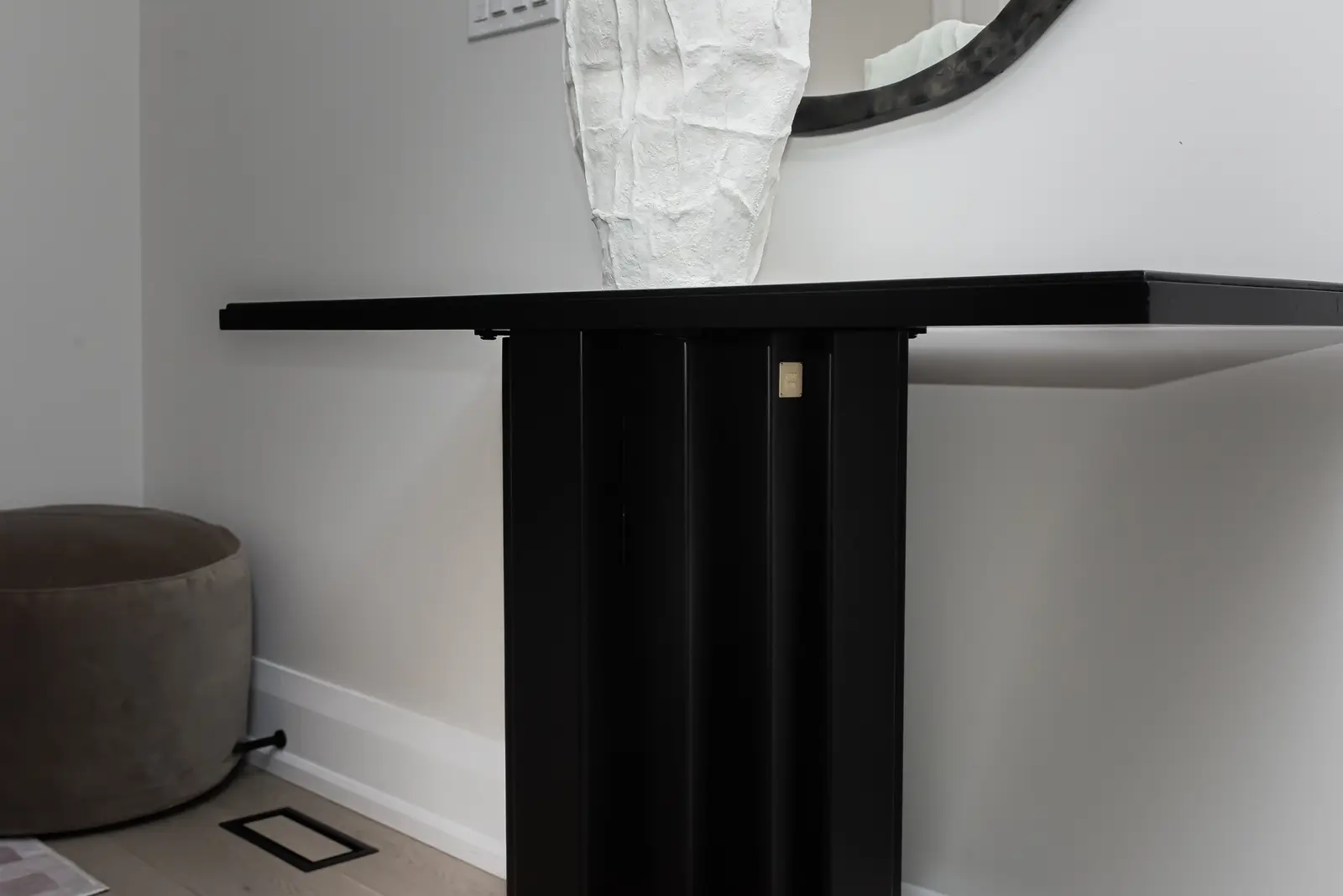 Interior of a Thornhill detached house renovation, with pale wood floors, black furnishings, and a walnut vanity in the primary bathroom.