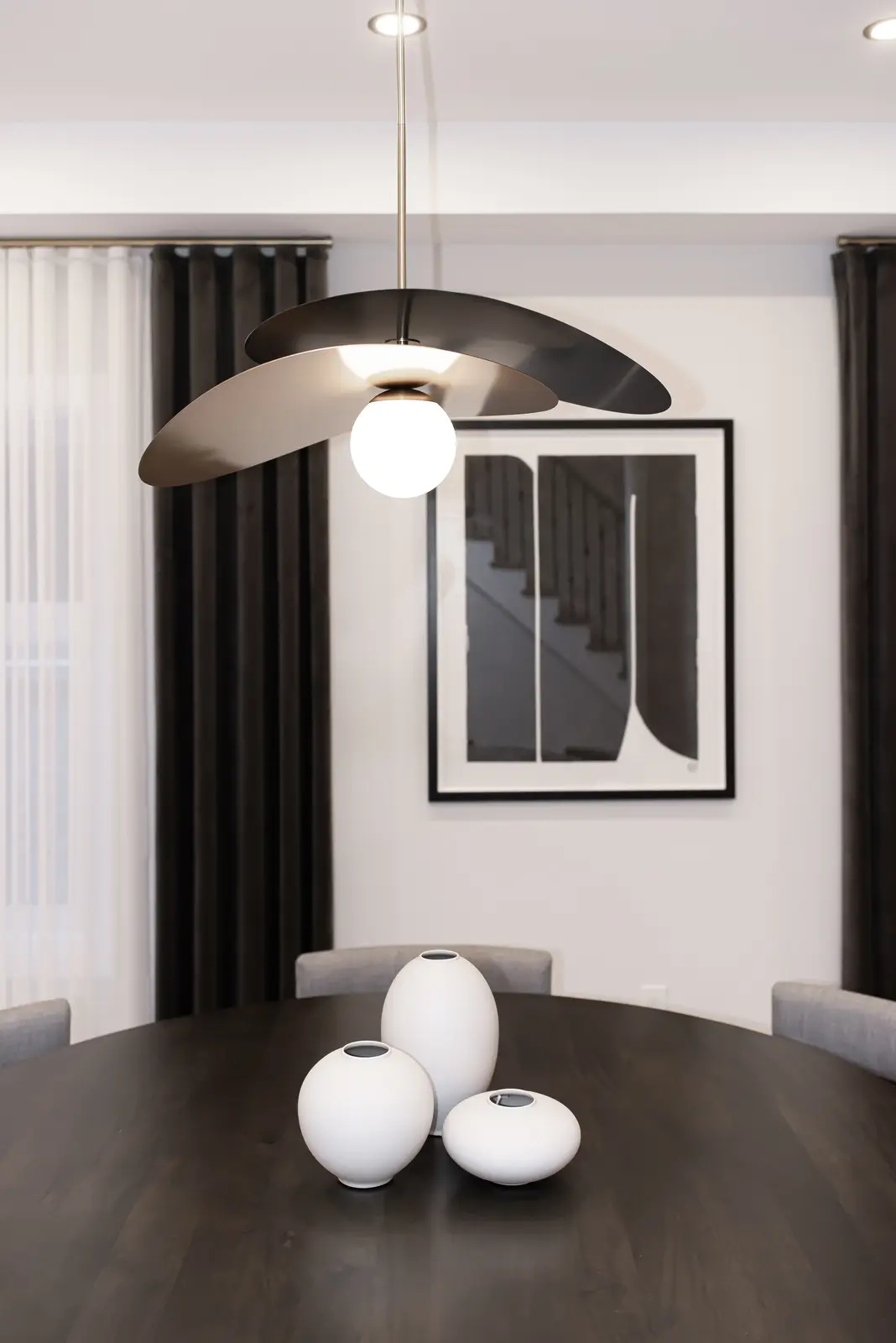 Interior of a Thornhill detached house renovation, with pale wood floors, black furnishings, and a walnut vanity in the primary bathroom.