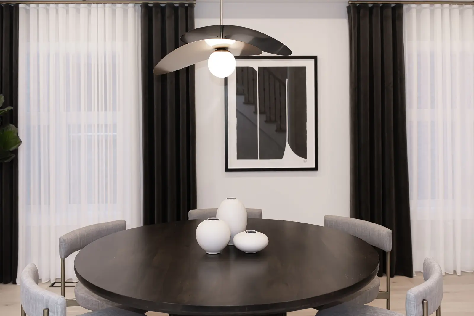 Interior of a Thornhill detached house renovation, with pale wood floors, black furnishings, and a walnut vanity in the primary bathroom.
