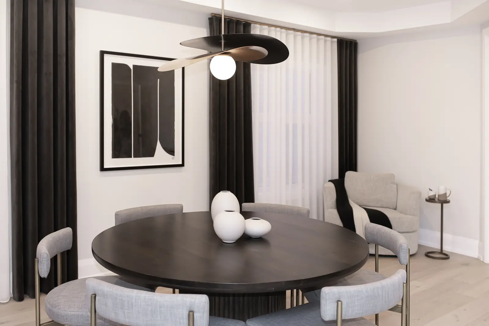 Interior of a Thornhill detached house renovation, with pale wood floors, black furnishings, and a walnut vanity in the primary bathroom.