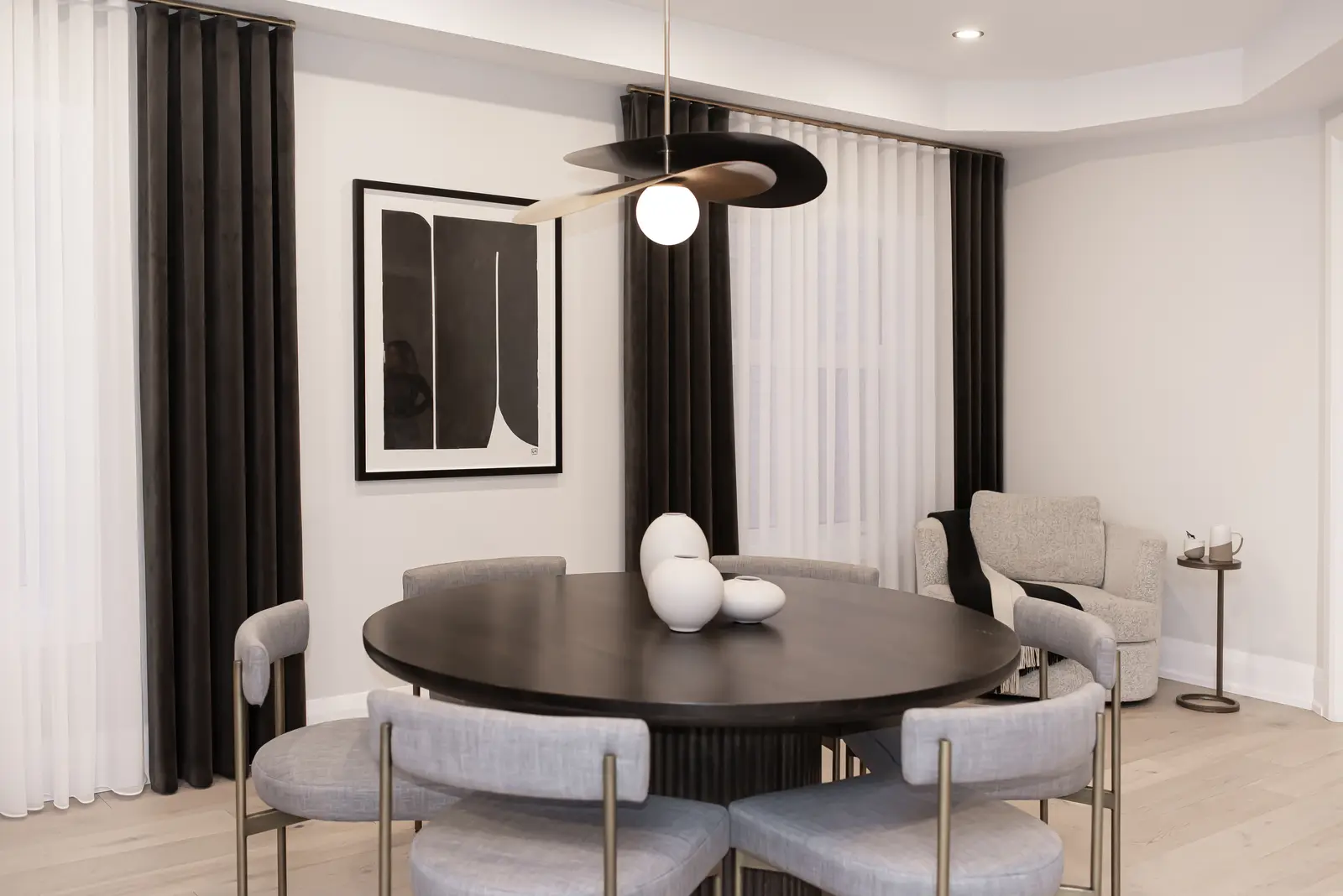 Interior of a Thornhill detached house renovation, with pale wood floors, black furnishings, and a walnut vanity in the primary bathroom.