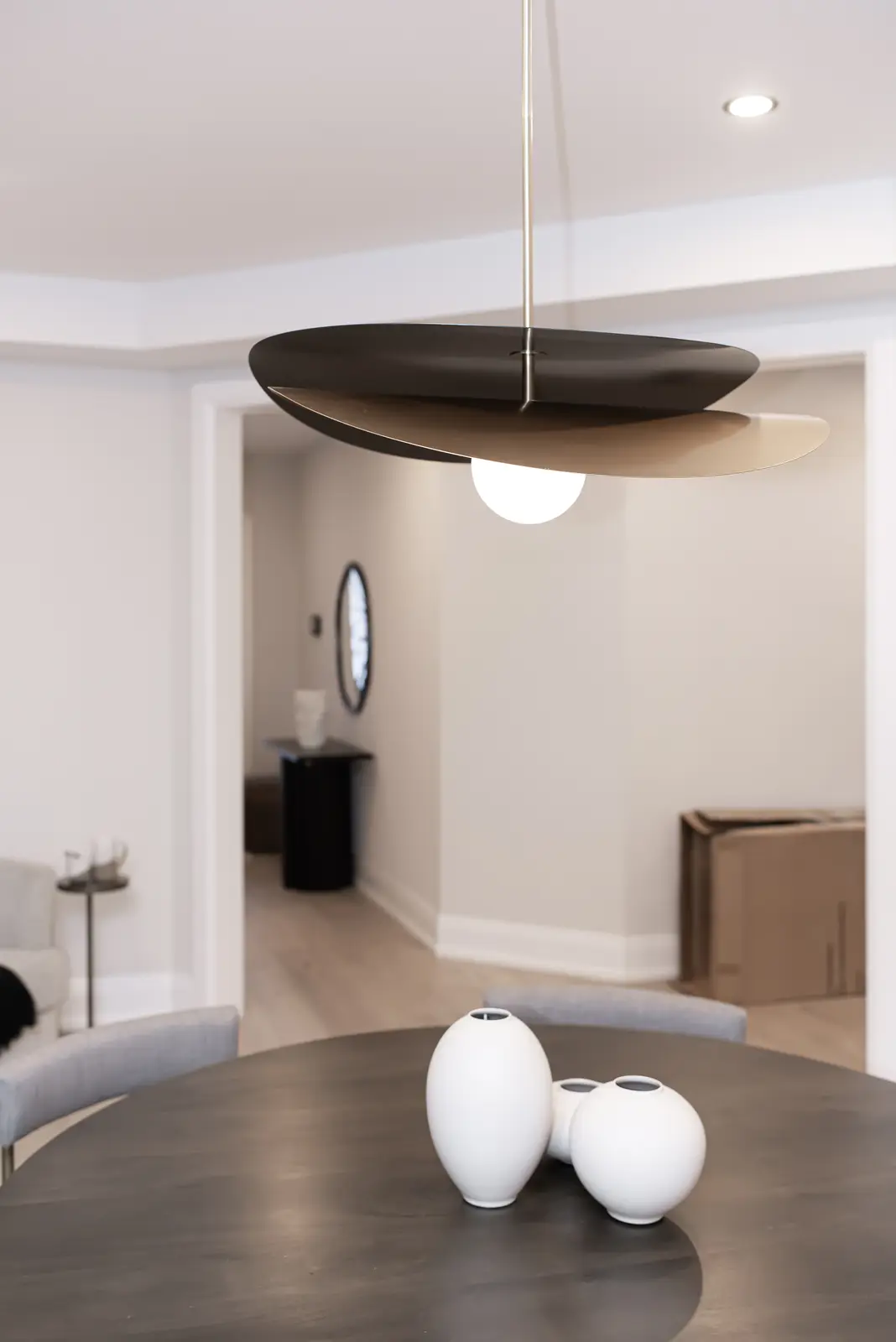 Interior of a Thornhill detached house renovation, with pale wood floors, black furnishings, and a walnut vanity in the primary bathroom.
